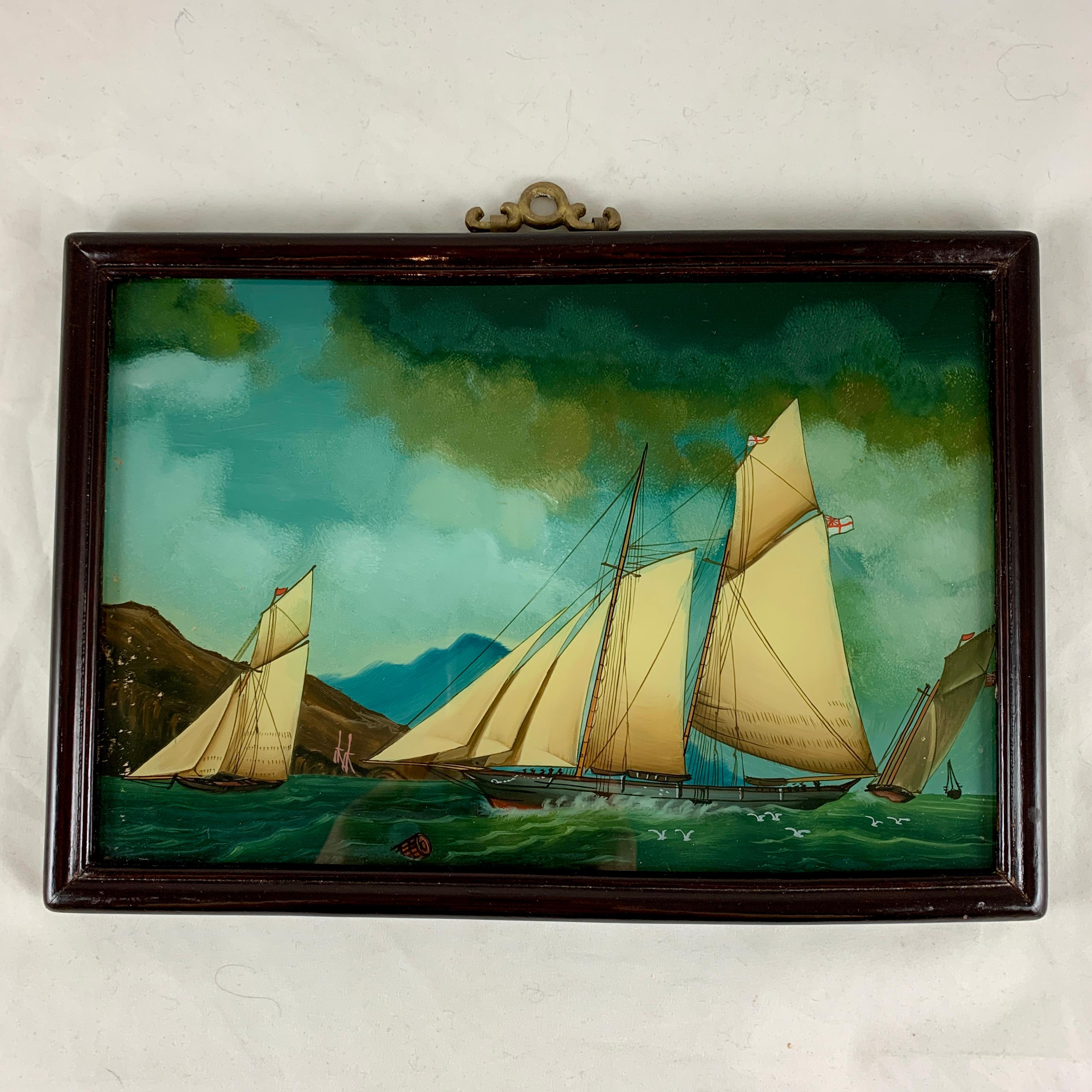 From France, a reverse glass painting of sailboats on the sea – “Voiliers Sur la Mer.” circa late 19th – early 20th century.

Reverse painting on glass is a traditional art form where the artist applies paint to a piece of glass, and the image is