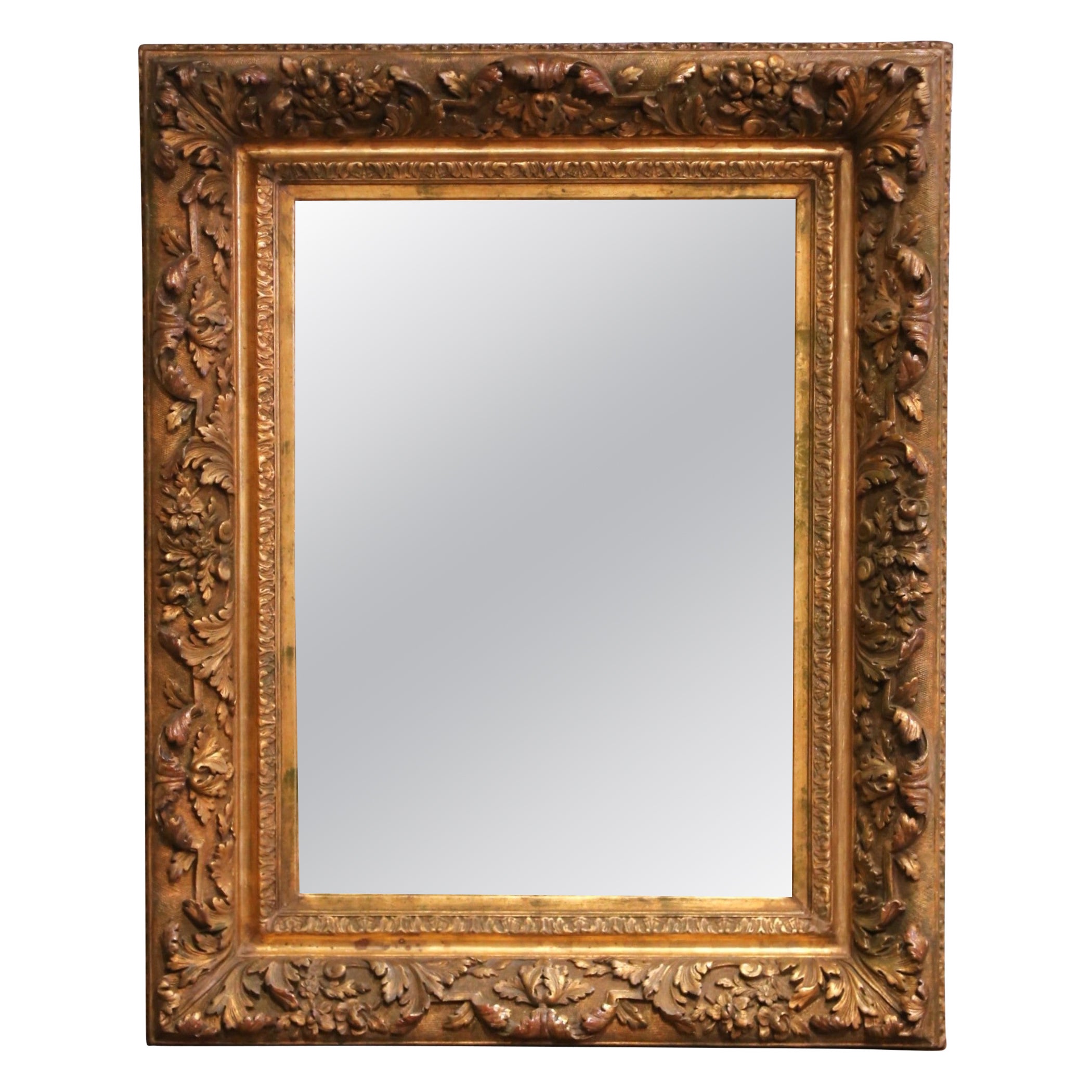 French C.I.C. Rococo Giltwood Mirror with Carved Floral and Foliate Motifs (Miroir en bois doré rococo français avec motifs floraux et feuillus sculptés)