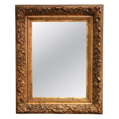 French C.I.C. Rococo Giltwood Mirror with Carved Floral and Foliate Motifs (Miroir en bois doré rococo français avec motifs floraux et feuillus sculptés)