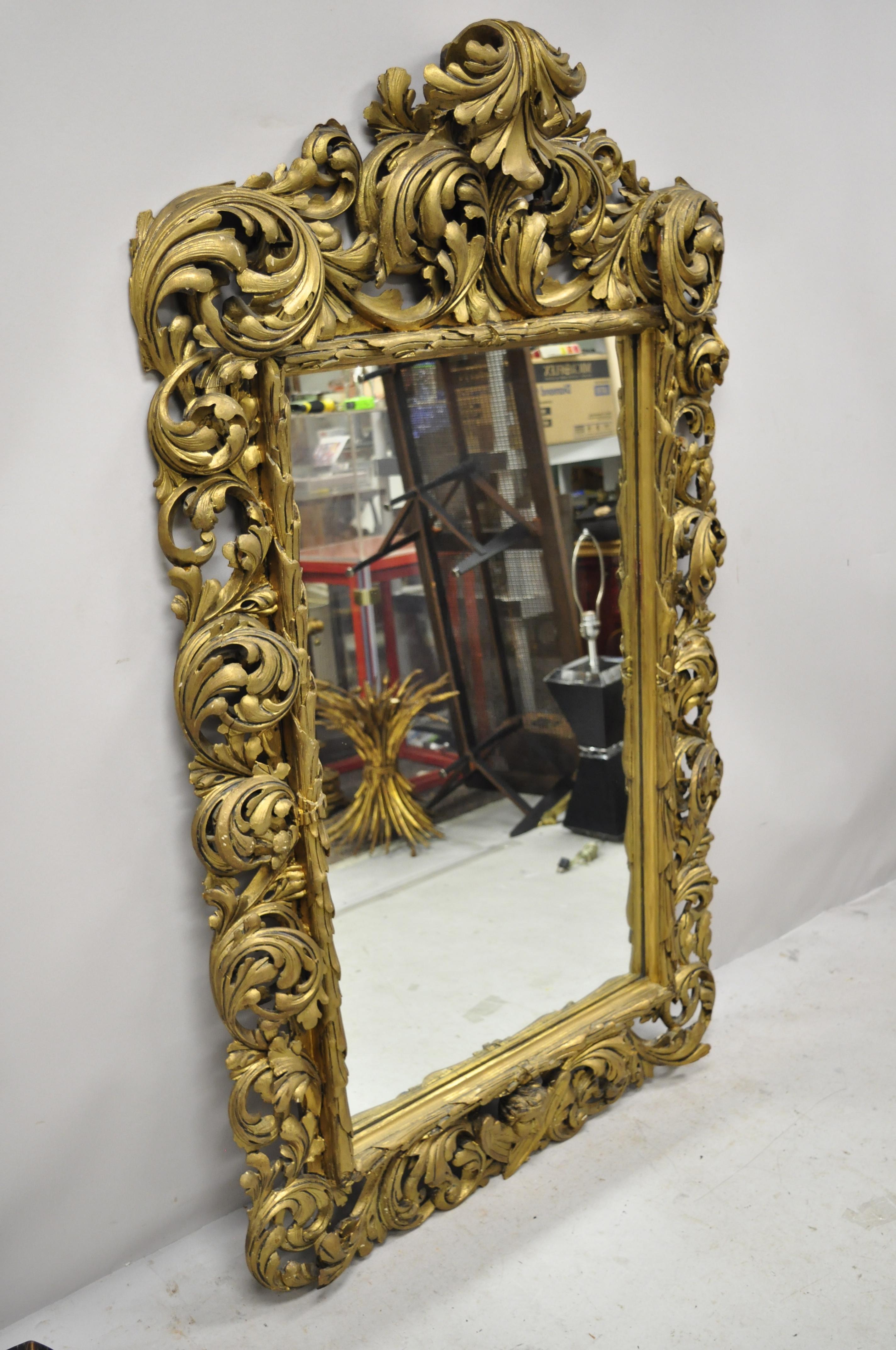 19th century French Rococo gold giltwood relief carved wood acanthus leaf wall mirror. Item features a hand carved wood frame, distressed gold gilt finish, pierce carved acanthus leaf frame, very nice antique item, circa 19th century. Measurements:
