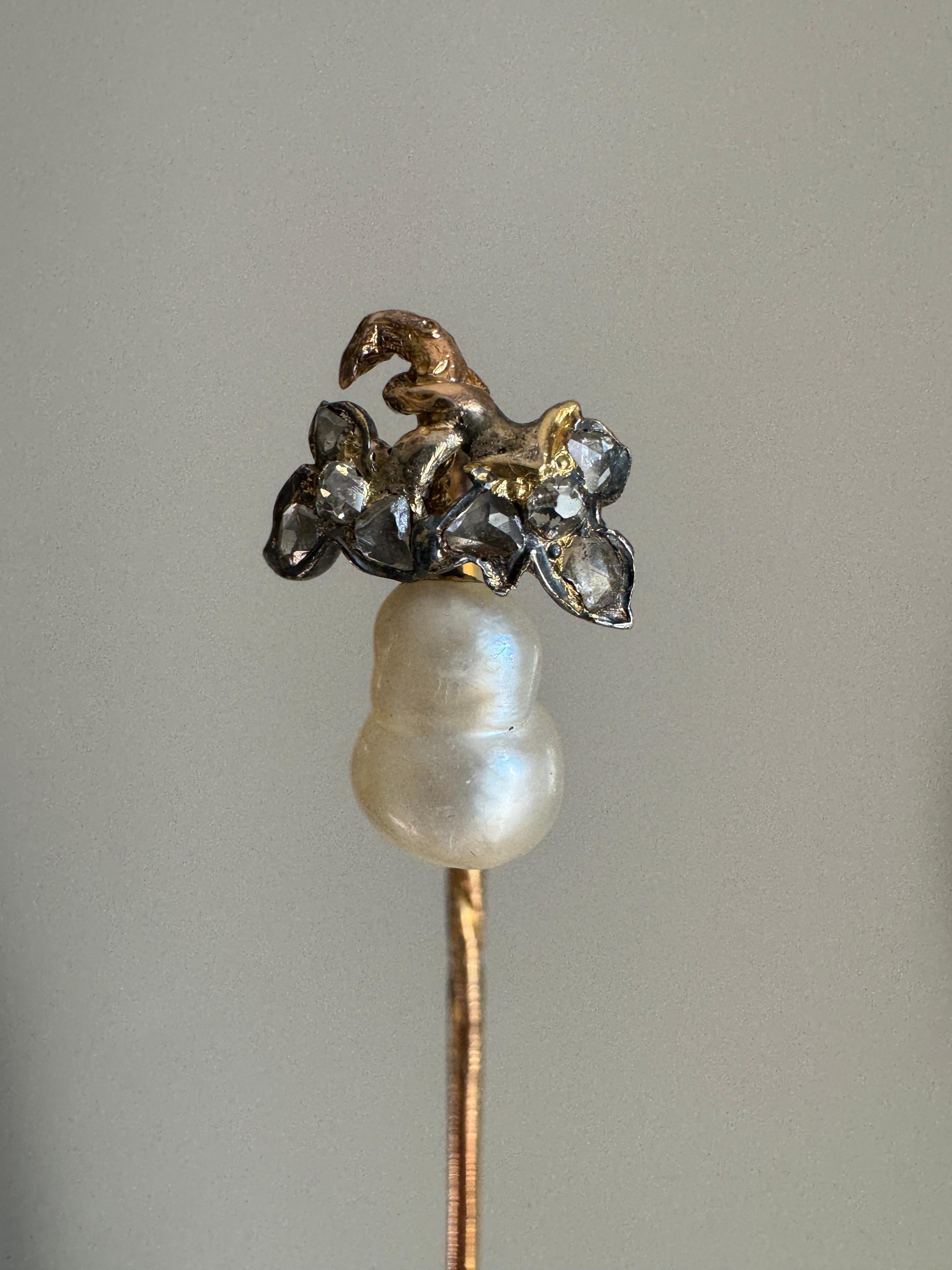 This precious pearl wonder dates to the mid 19th C France. Artfully hand fabricated in silver and 18 karat gold, a lustrous pear shaped pearl is perfectly adorned by a pair of softly shimmering diamond-set leaves. A miniature work of art!

Pearl: