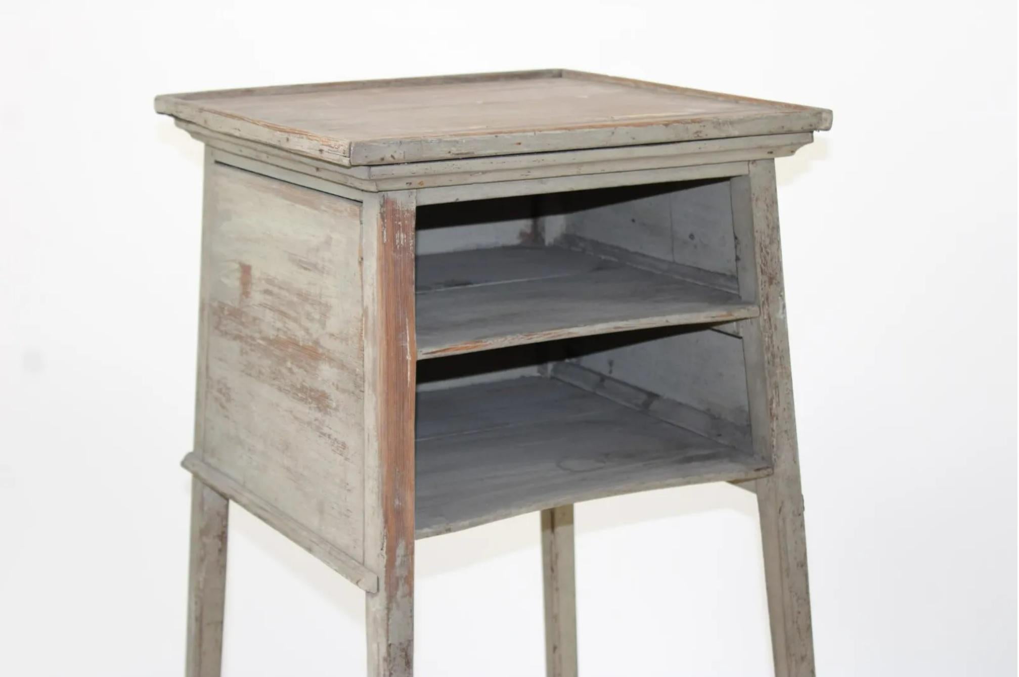 19th c. French grey painted oak rustic stand or pedestal side table with interior shelves and casters.