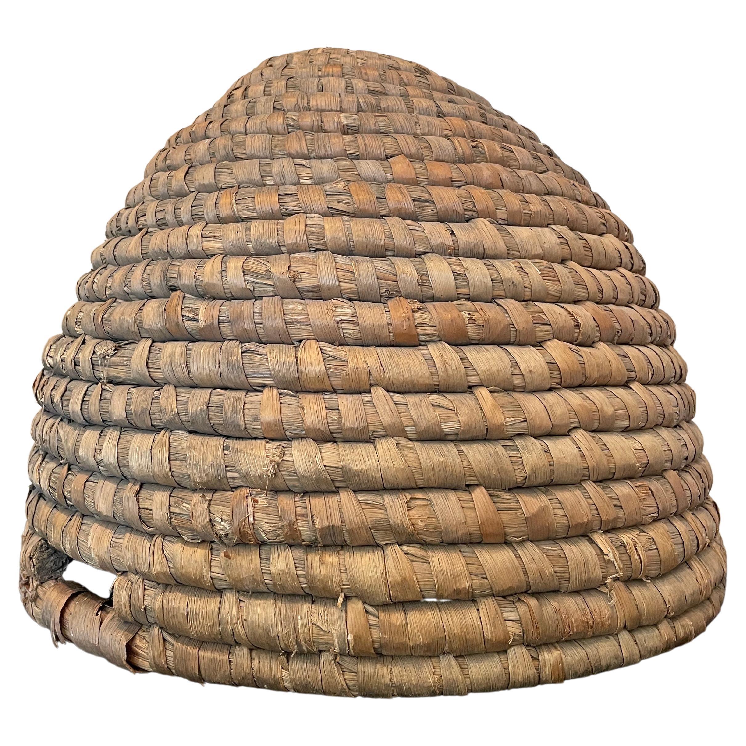 A bee skep is a traditional round hive made of straw or dried grass. Multiple strands of straw are bundled together to form a thick rope and the rope is then coiled and bound together to make the skep.

The word skep is thought to have come from