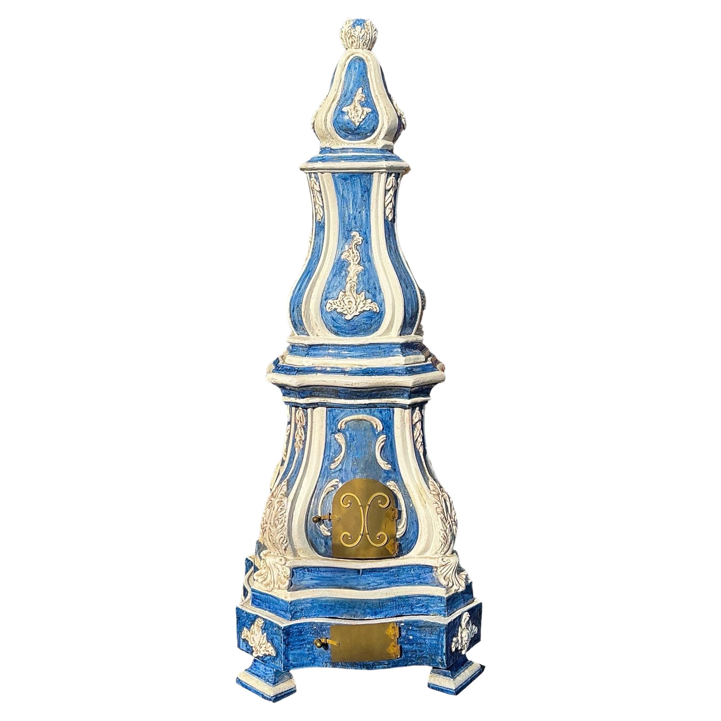 I always love these! This is a lovely 19th century French blue and white glazed terracotta stove. It is comprised of five separate stacking sections plus the four feet. It has a vivid blue and white majolica glaze with brass doors. A rare find!

My