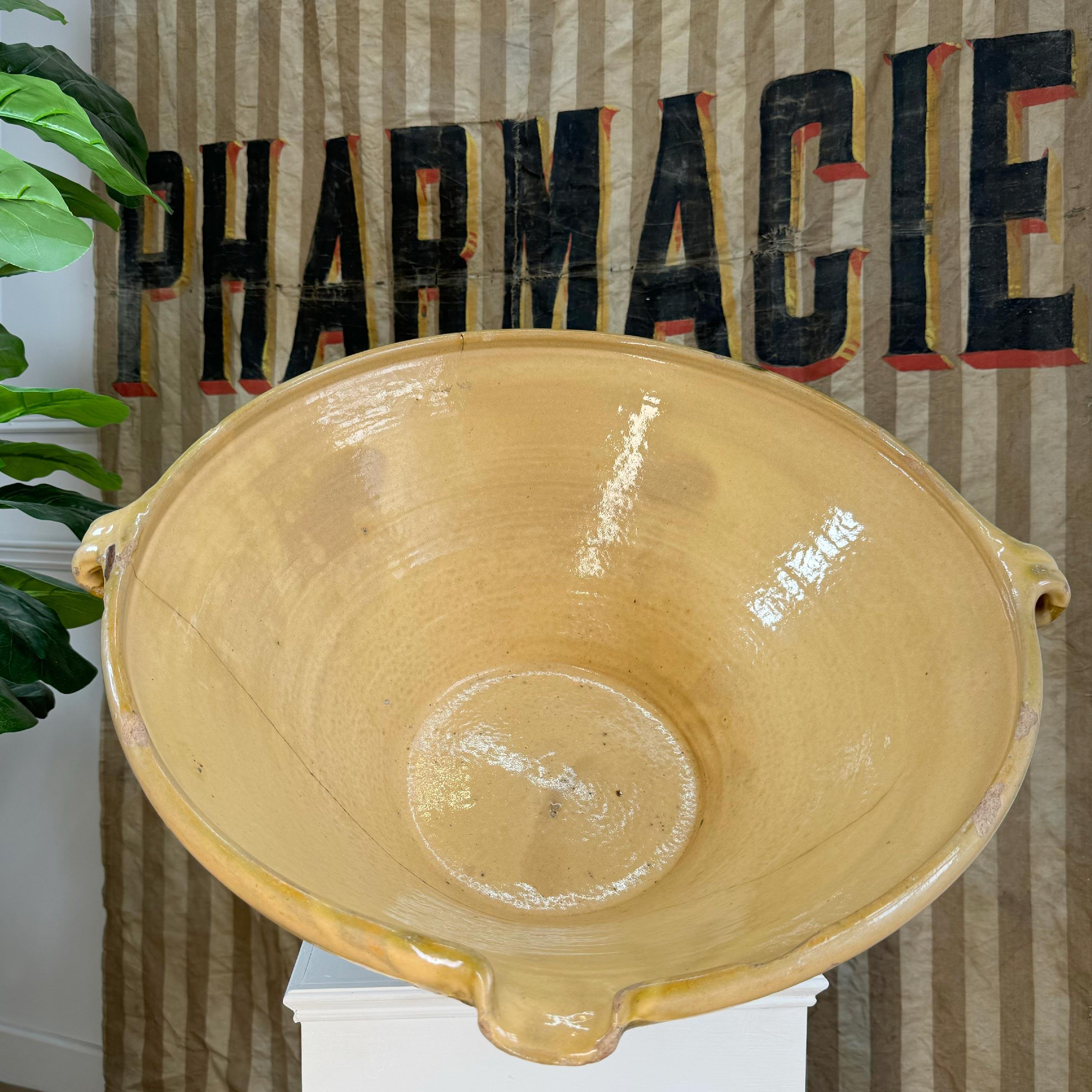 19th Century tian bowl from Provence in the south of France, traditionally used for preparing food in the 19th century, this large bowl has been used and loved and has the most exquisite ancient staple repair which only adds to the charm of this