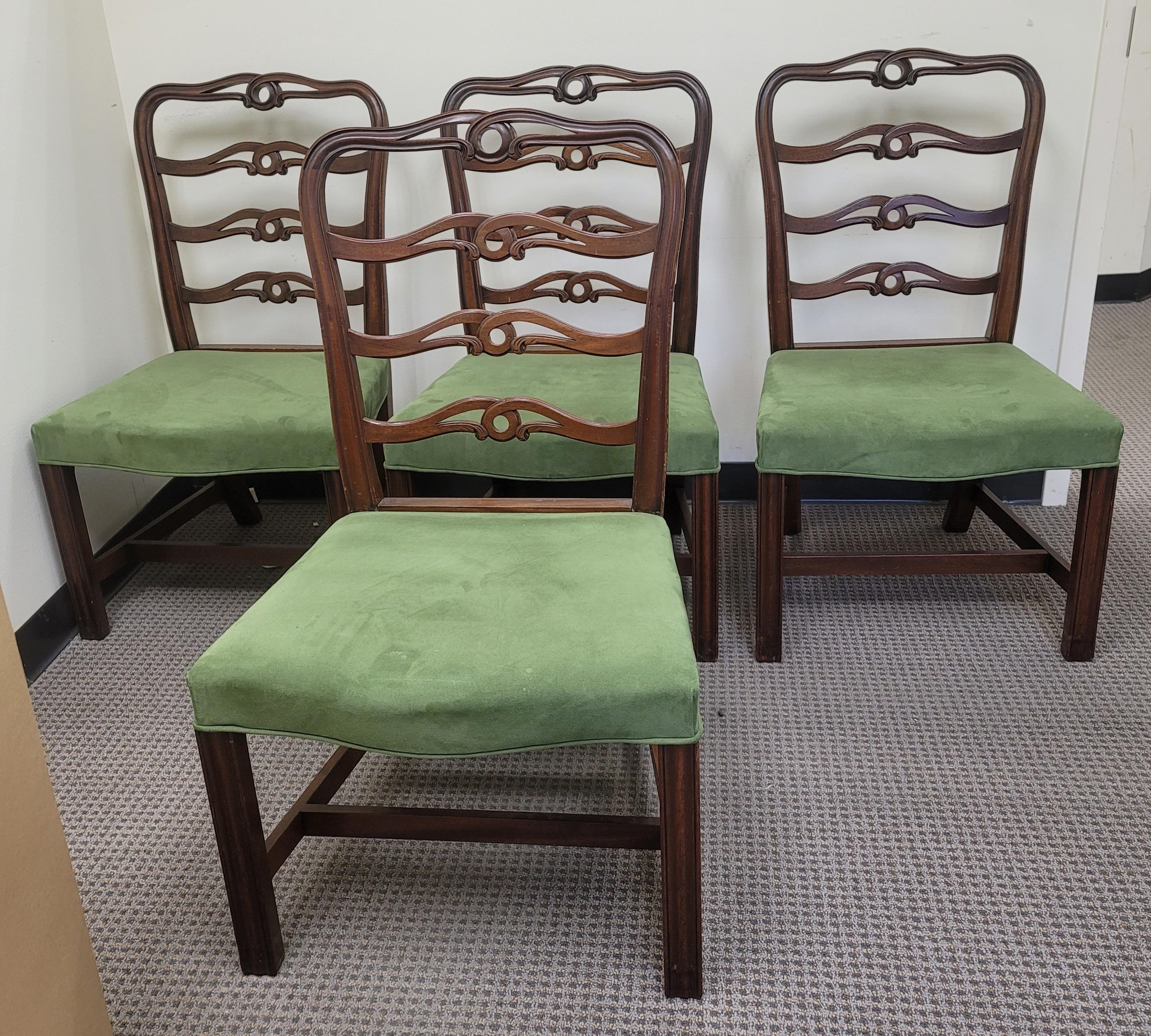 Late 19th century English Georgian set of 4 ladder back dining chairs, shaped and pierced cresting and back rails, suede leather upholstered seat cushion above square fluted front supports, joined by 'H' stretcher. Newer suede leather upholstery.
  