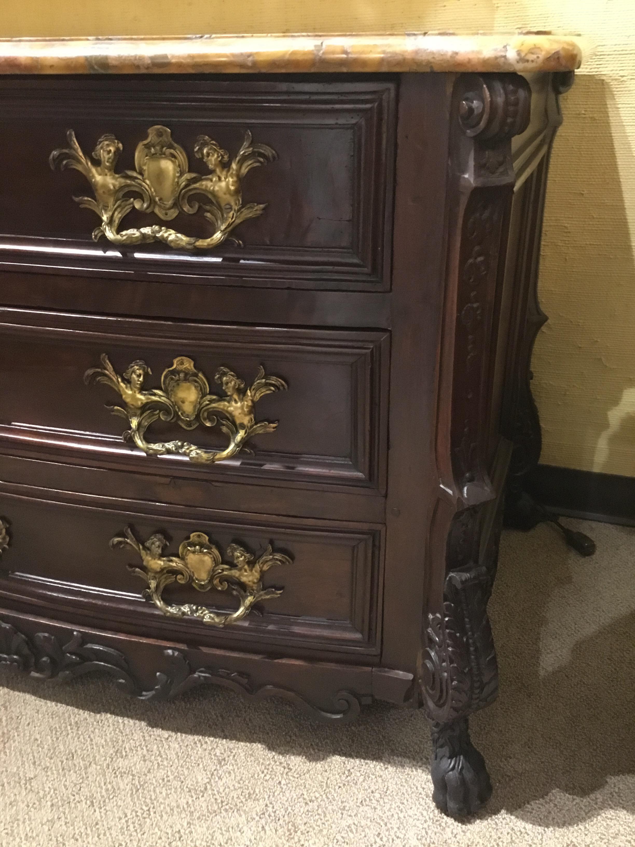Unique and handsome rosewood chest of drawers with a marble top in shades of gold and amber.
Carving down each side of this piece ends in carved paw. Paneled sides are very deep. This
Is a sturdy and very well made piece. It dates to the 1860s and