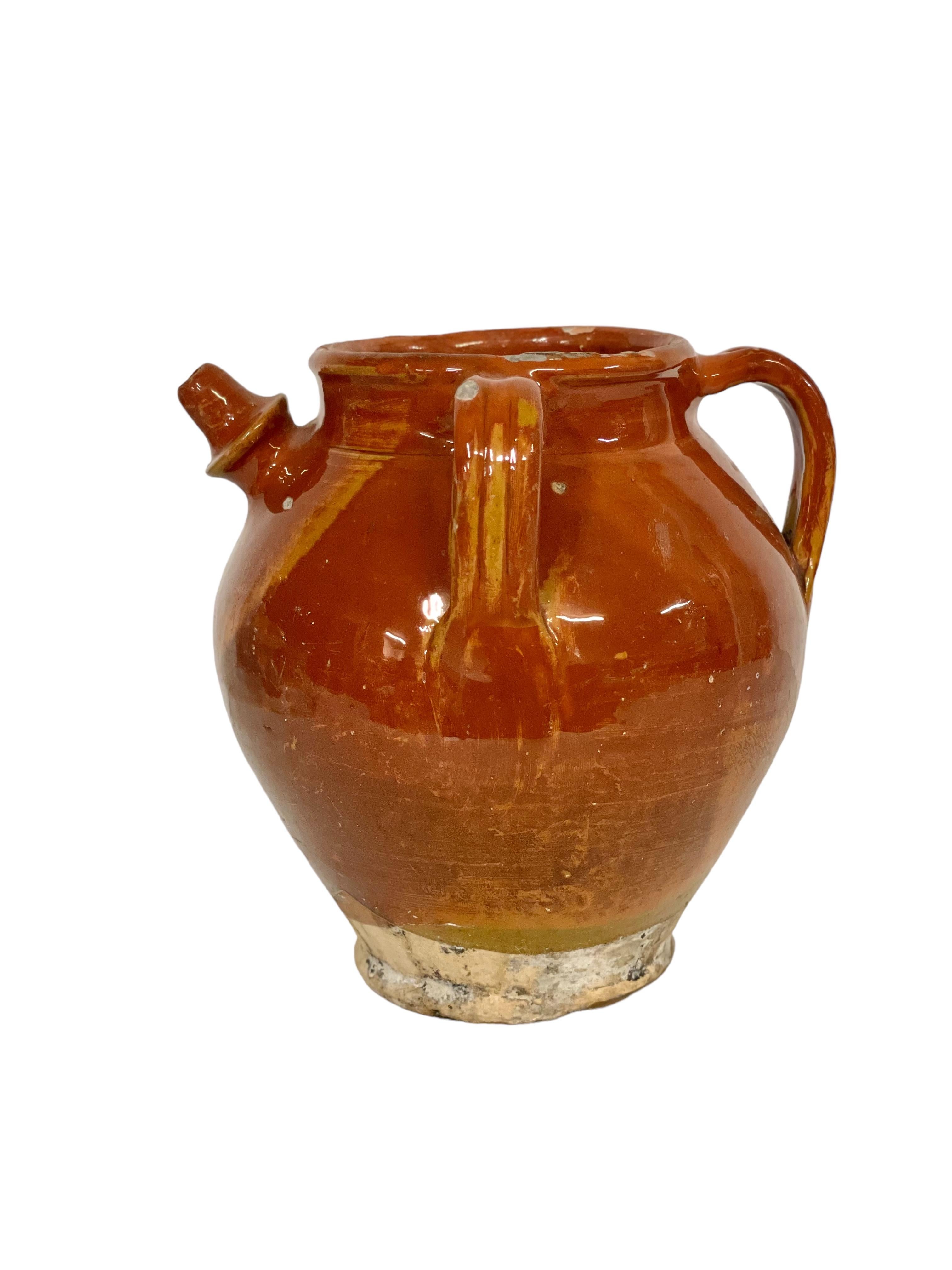 A very pretty petite glazed jug originating from the Dordogne region of south-west France and dating from the 19th century. Originally conceived for the storage and preservation of nut oils in a country kitchen, it may also have been used to store