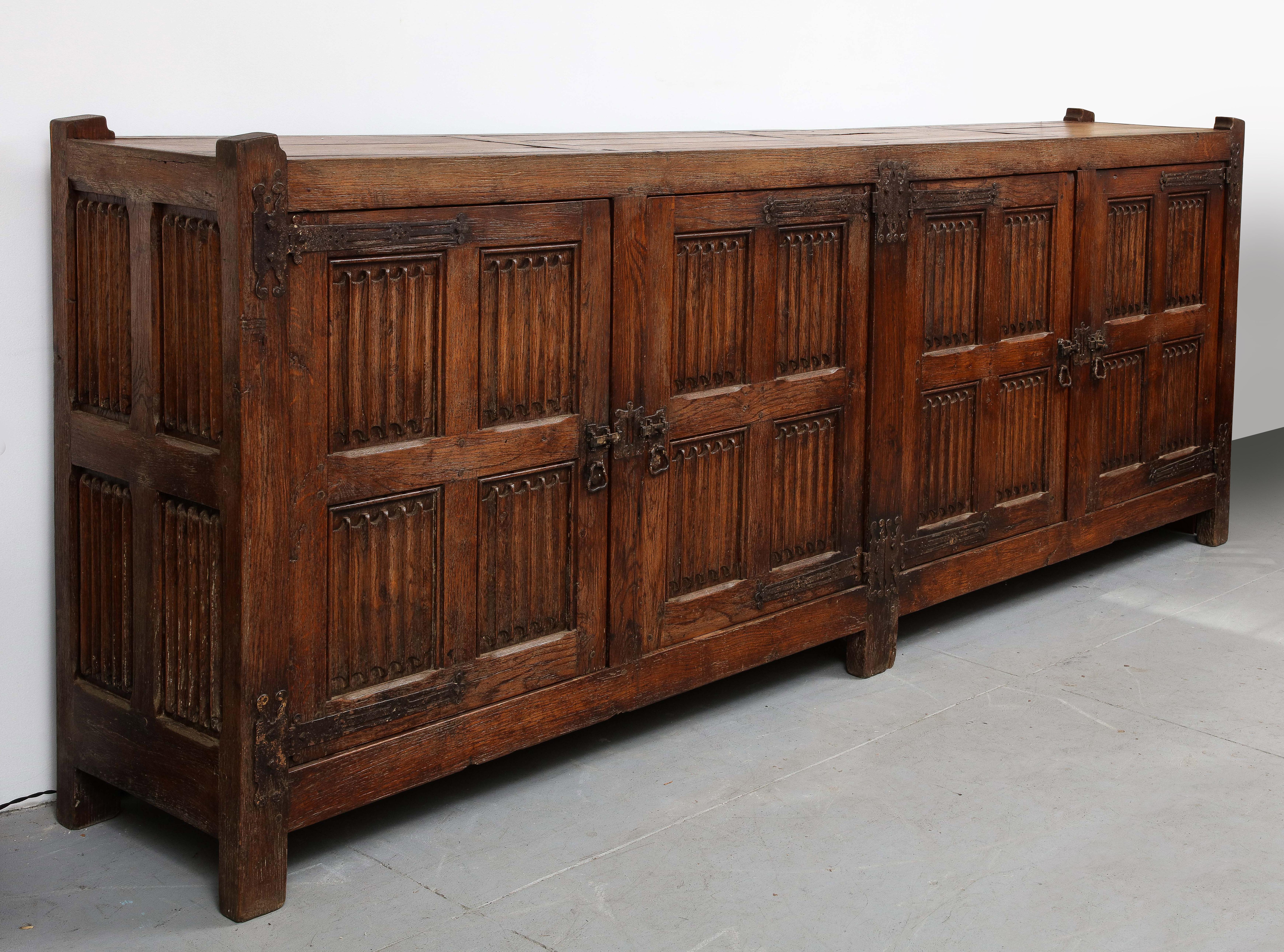The hand carving technique is called linenfold, and it has wonderful hand wrought iron hardware.  It is in wonderful condition, has a nice glow, and all original.  It came from a Nunnery in France.

19th C. Hand Carved Oak Sideboard with