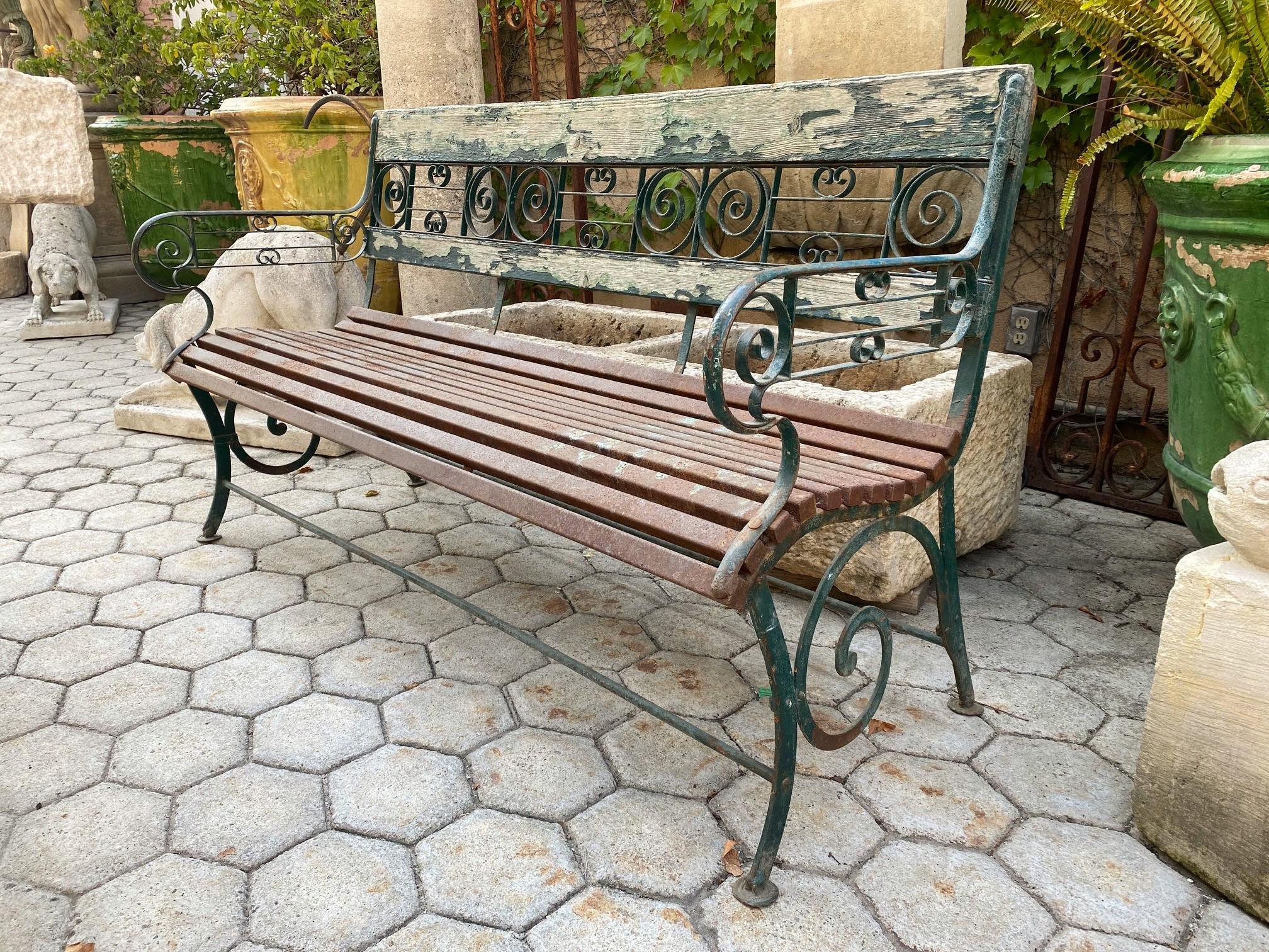 Large 19th century Art Nouveau hand forged metal and wood slats garden bench. This rustic antique beauty is a nice piece indeed a beautiful garden bench simple lines that works in an interior as a seating or decorative architectural focal point
