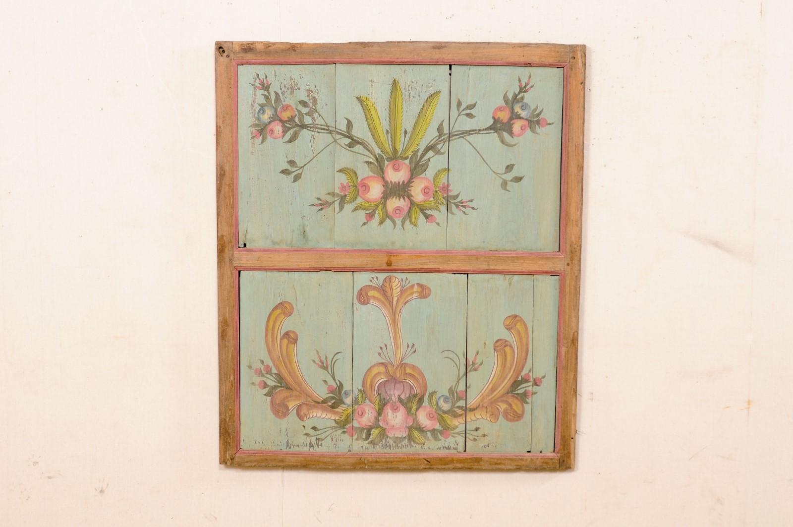 A European hand-painted wooden wall panel from the 19th century. This antique wall plaque from Europe (possibly German or Austrian) is comprised of a rectangular-shaped frame, with two recessed board panels (one atop the other). The inset panels