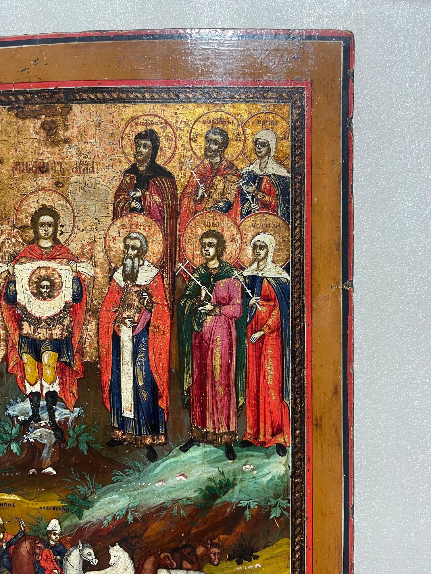 Bois Icône du 19ème siècle, St. Floros et Lauros avec l'Archangel Michael tenant le visage du Saint-Esprit en vente