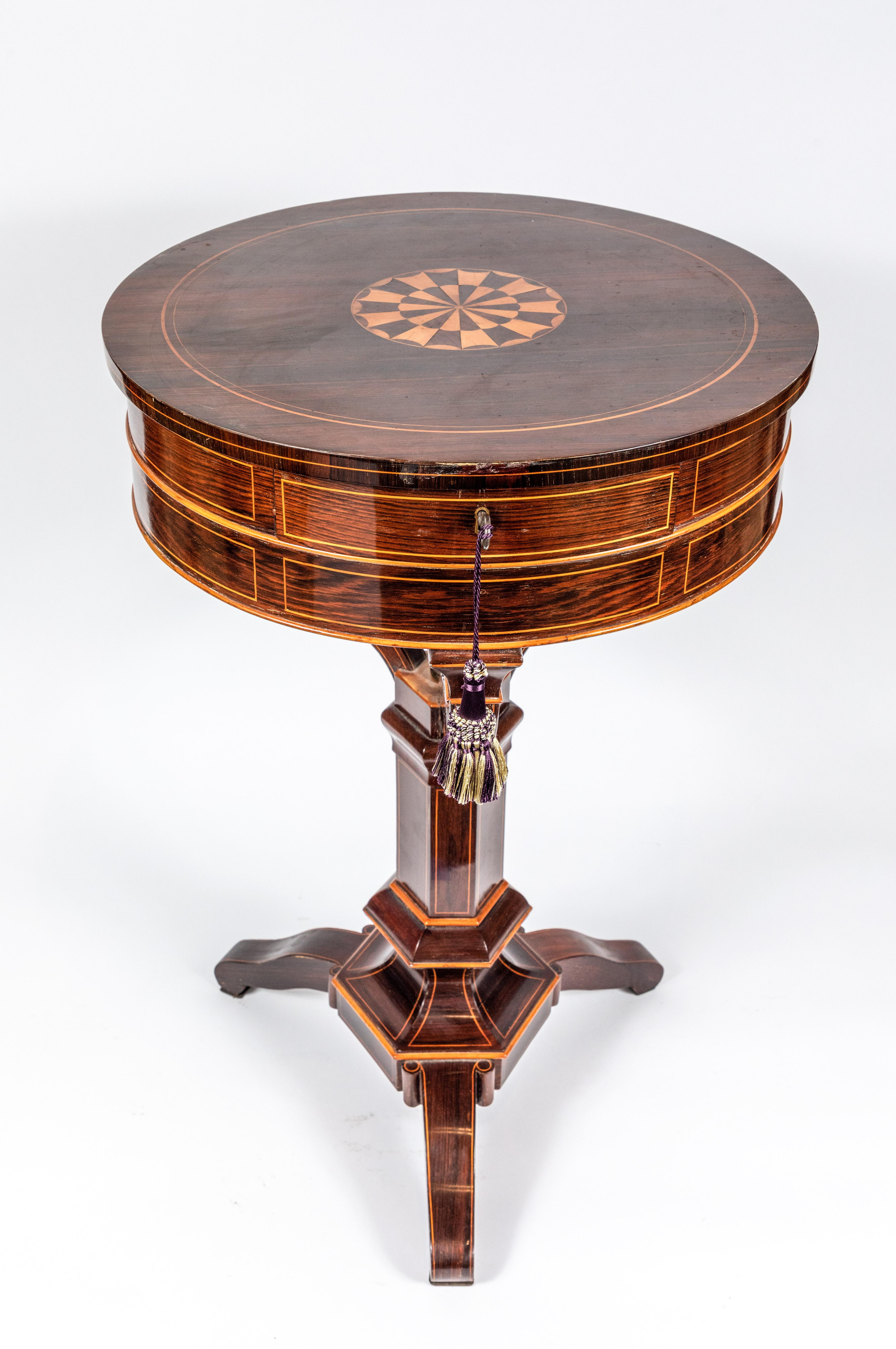 Petite, beautifully veneered and inlaid, circular, two-drawer Biedermeier-style pedestal side table on a tripod foot.
