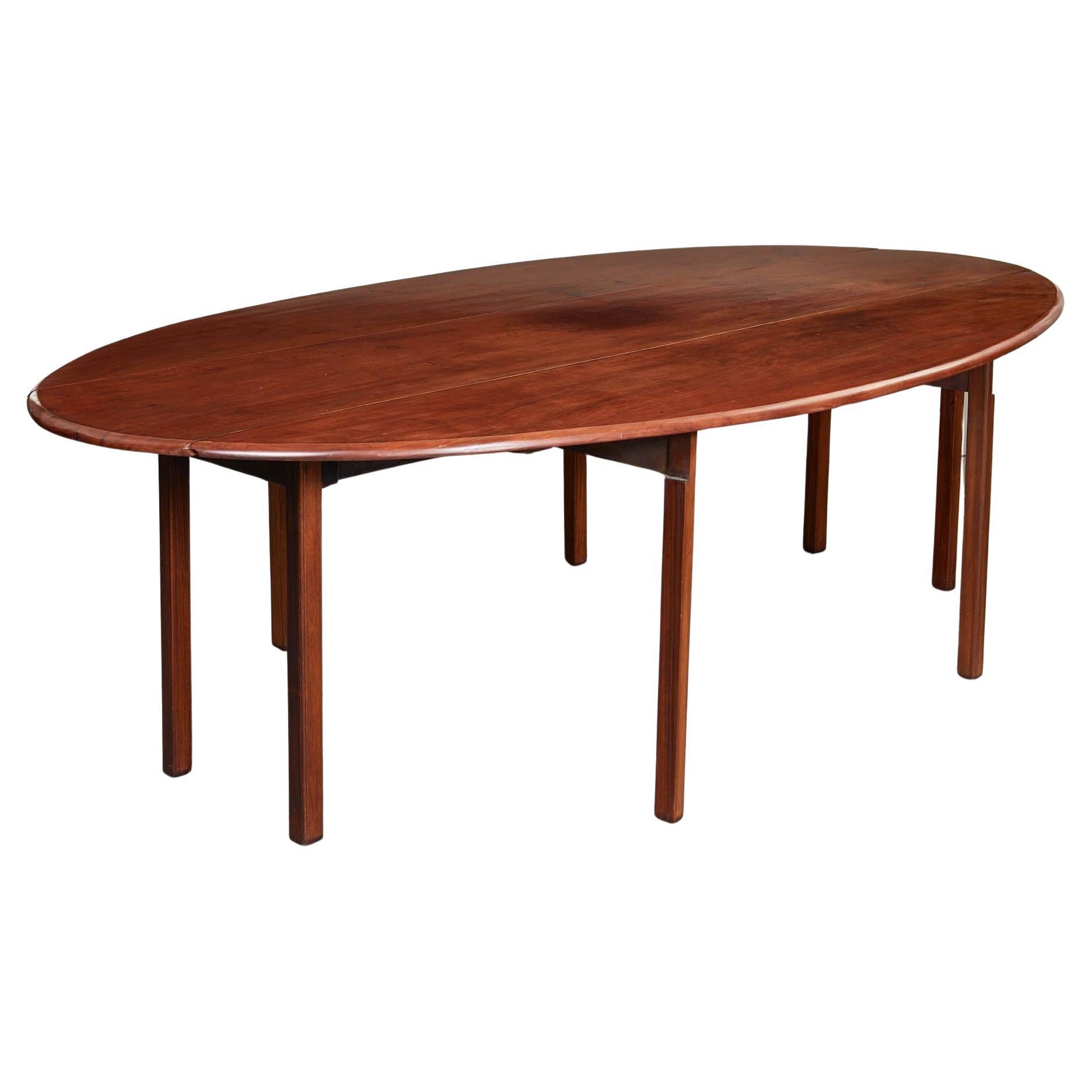 A large 19th century folding leaf table, known as a hunt table, made of excellent quality mahogany timber and possessing great mellow color. Elegant and simple design with eased ogee edge all round oval top, with four square section legs to center