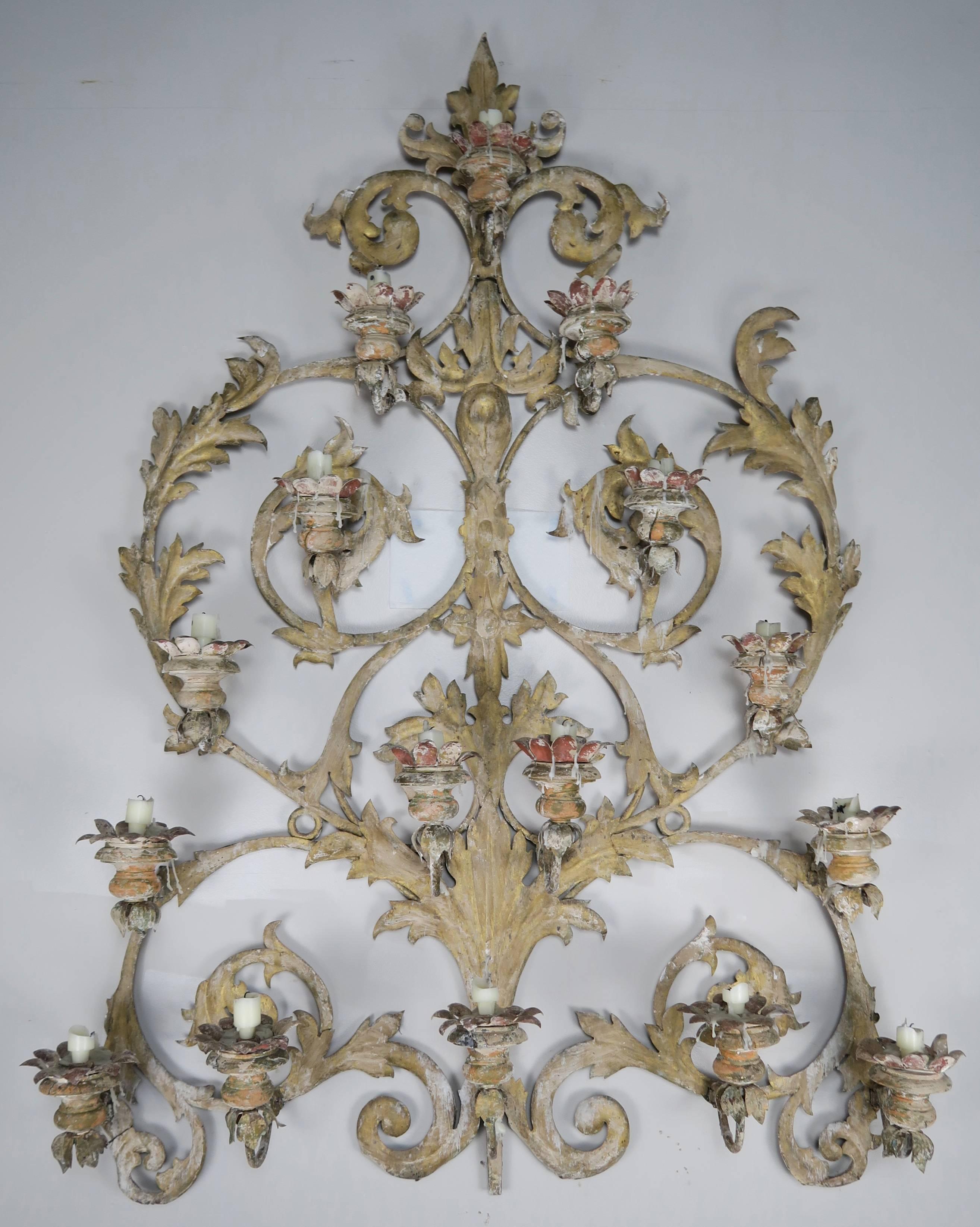 Italian 19th century 16-light painted iron and wood candelabra style wall ornament for candles. This fabulous one-of-a-kind unique piece is made up of 16 wooden and iron bobeches that hold candles in place. Swirling acanthus leaves throughout. A