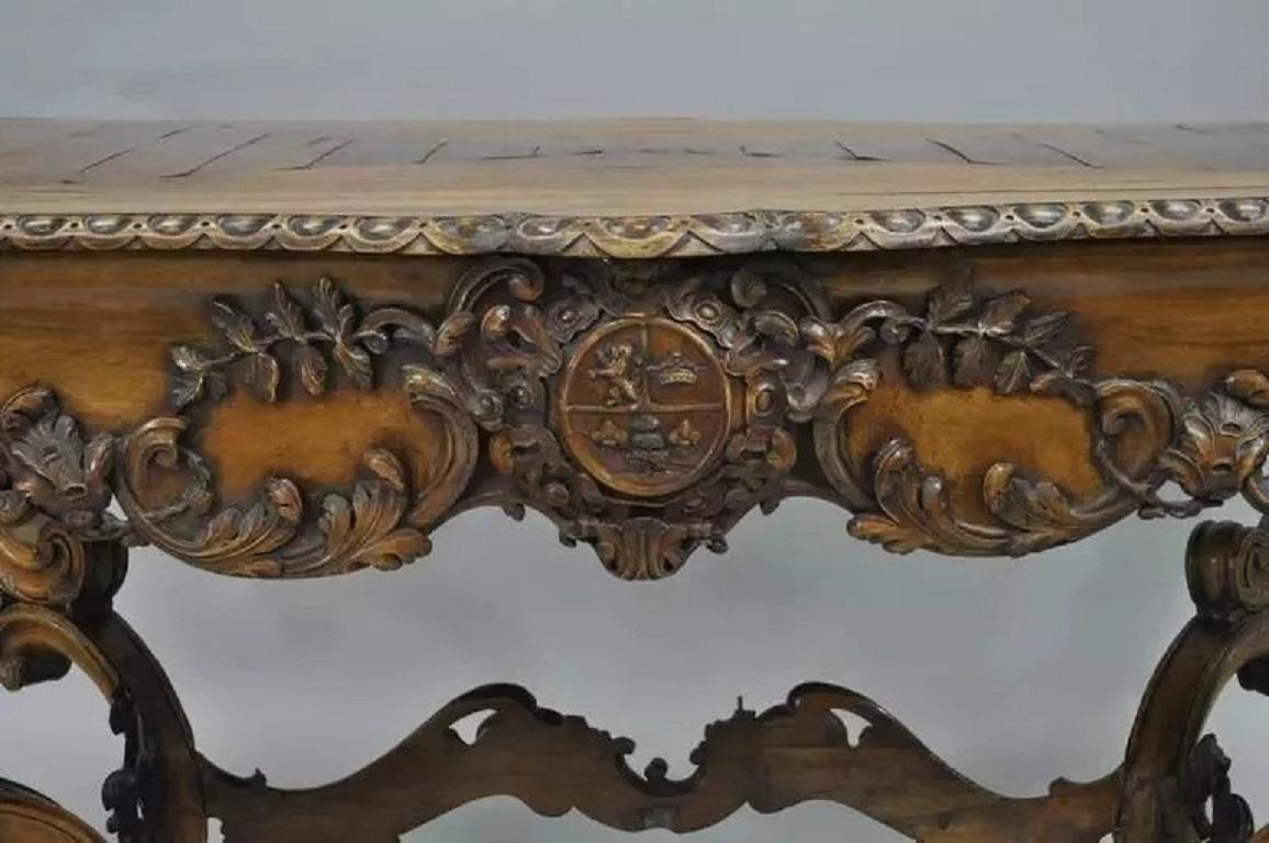 Antique Italian Baroque Carved Walnut Center Table in the French Louis XV Taste. Item features carvings throughout including the shapely acanthus form legs, stretcher base, plank inlaid walnut top, ball and claw feet and different central carvings