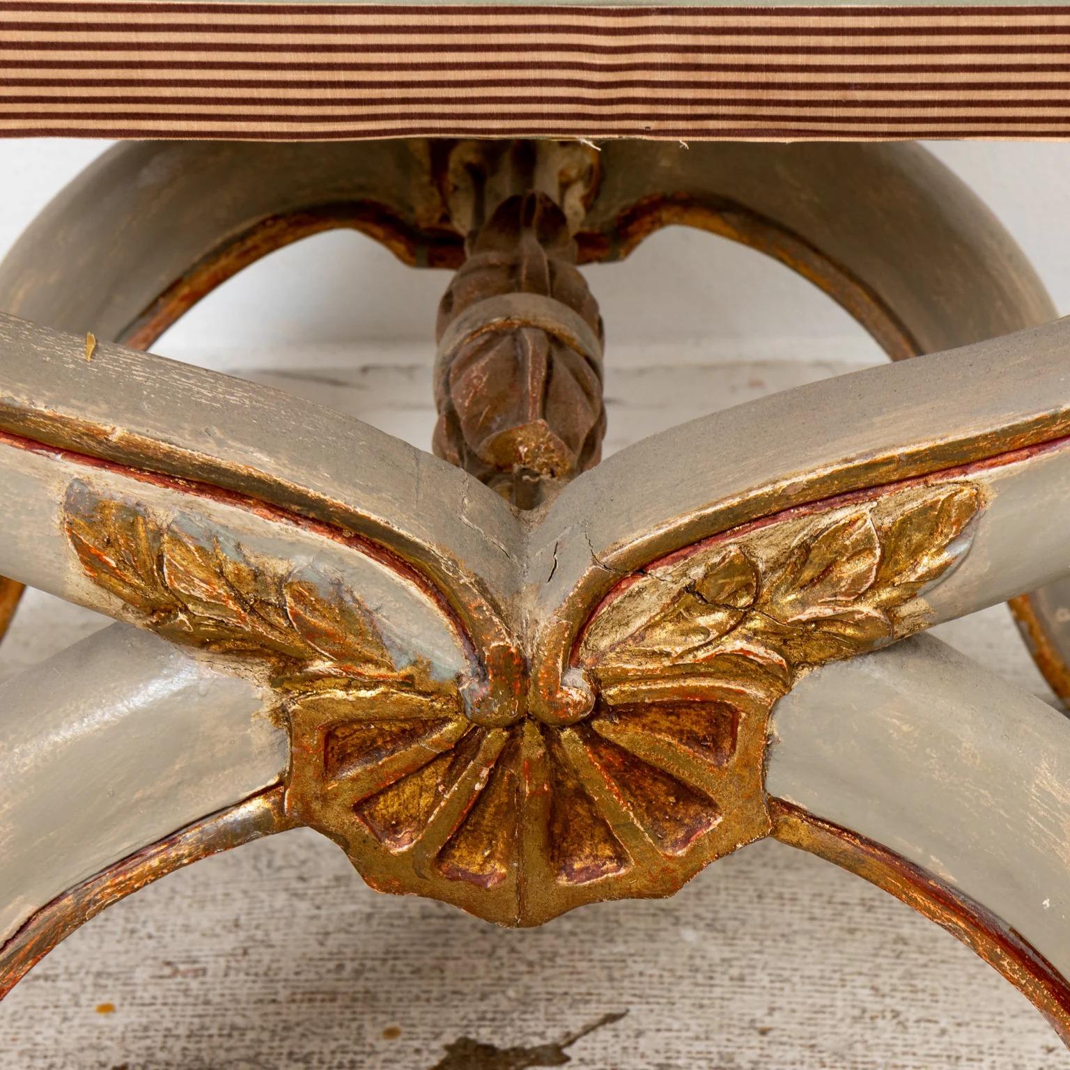 Paint and gilt decorated Italian neoclassical bench with silk upholstery and x form base. Please note of wear consistent with age.
