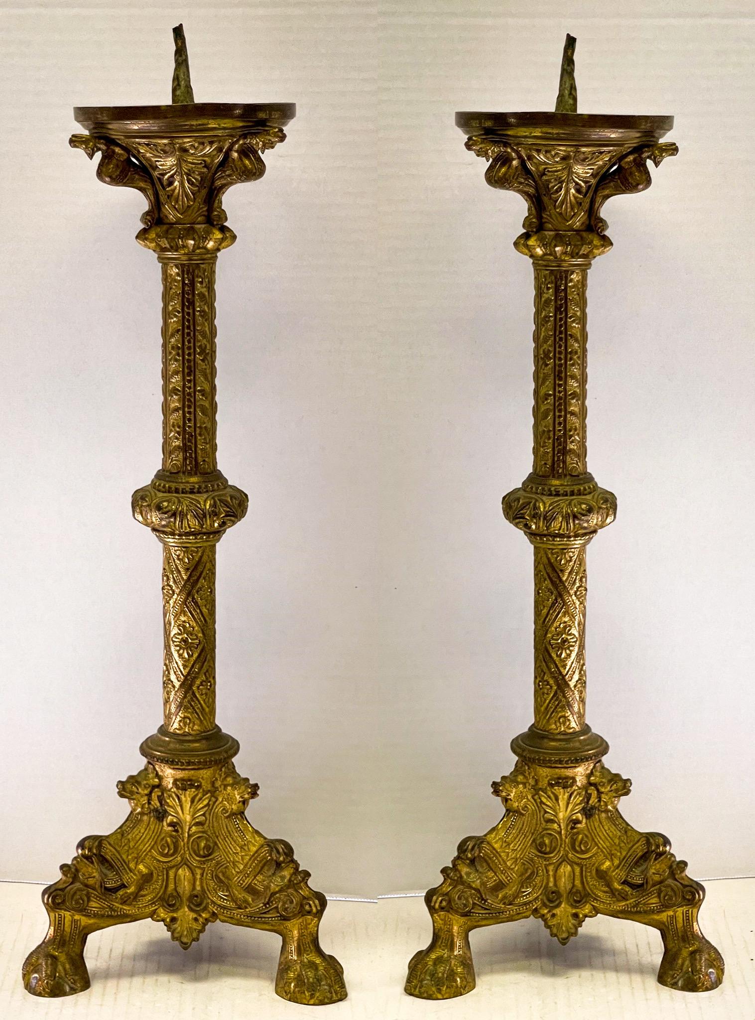 This is an amazing pair of 19th century Italian brass repousse church alter candlesticks. Note the clawed feet with the exceptional detail. Another special feature is the three serpents that are supporting the candle cups!