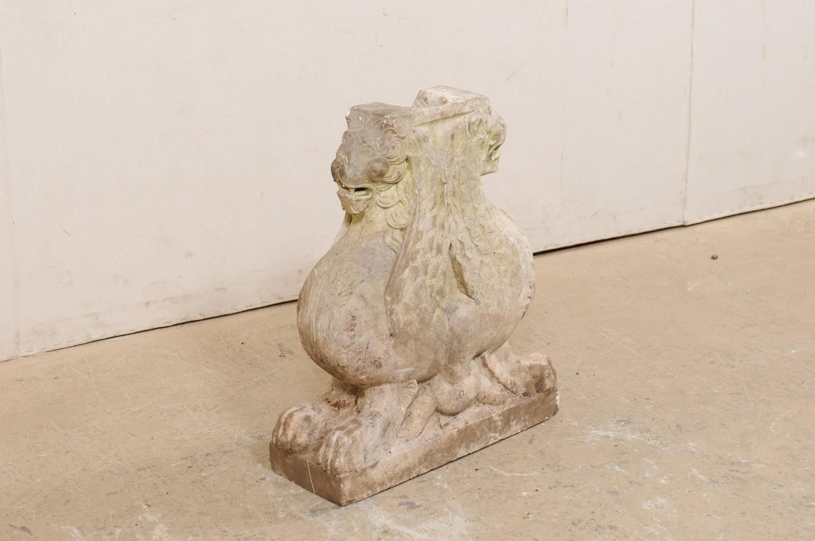 An Italian hand-carved marble fragment base from the 19th century. This antique marble sculpture from Italy features a carved pair of Griffins (a traditional symbol of Venice), seated back-to-back and looking straight forward, making up a continuous