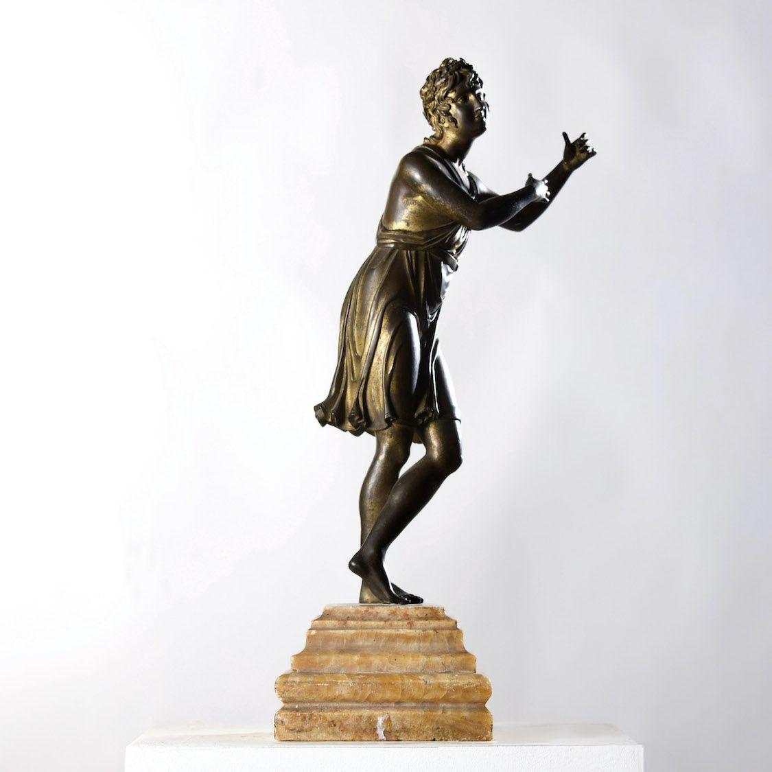 A  beautiful gilt bronze figure of Apollo on an alabaster base.  Dimensions:  17.32 inches high x 5.13 inches wide x 5.13 inches deep (width and depth measured at the base).