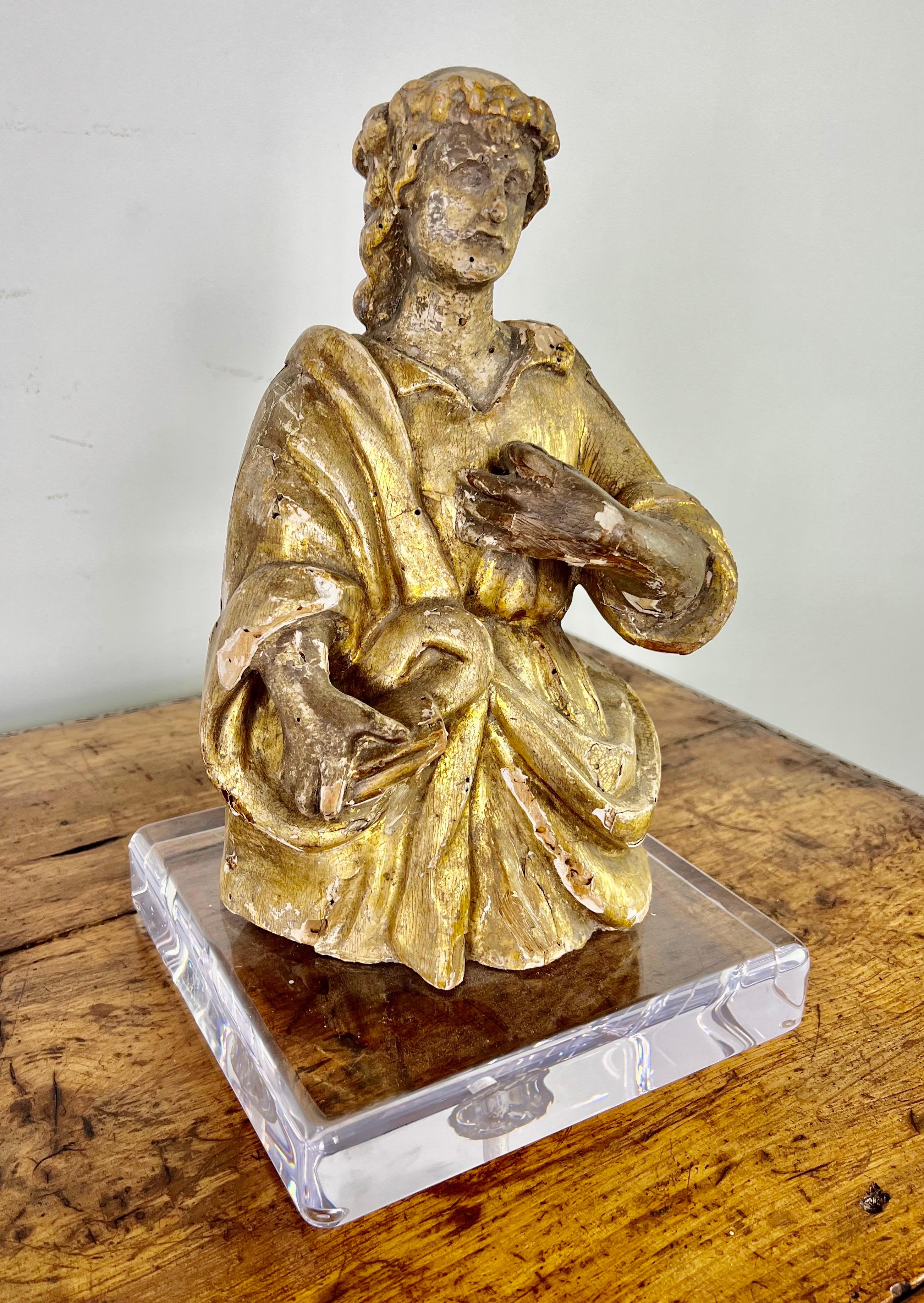 19th century Italian hand carved giltwood religious figure mounted on a contemporary lucite base.