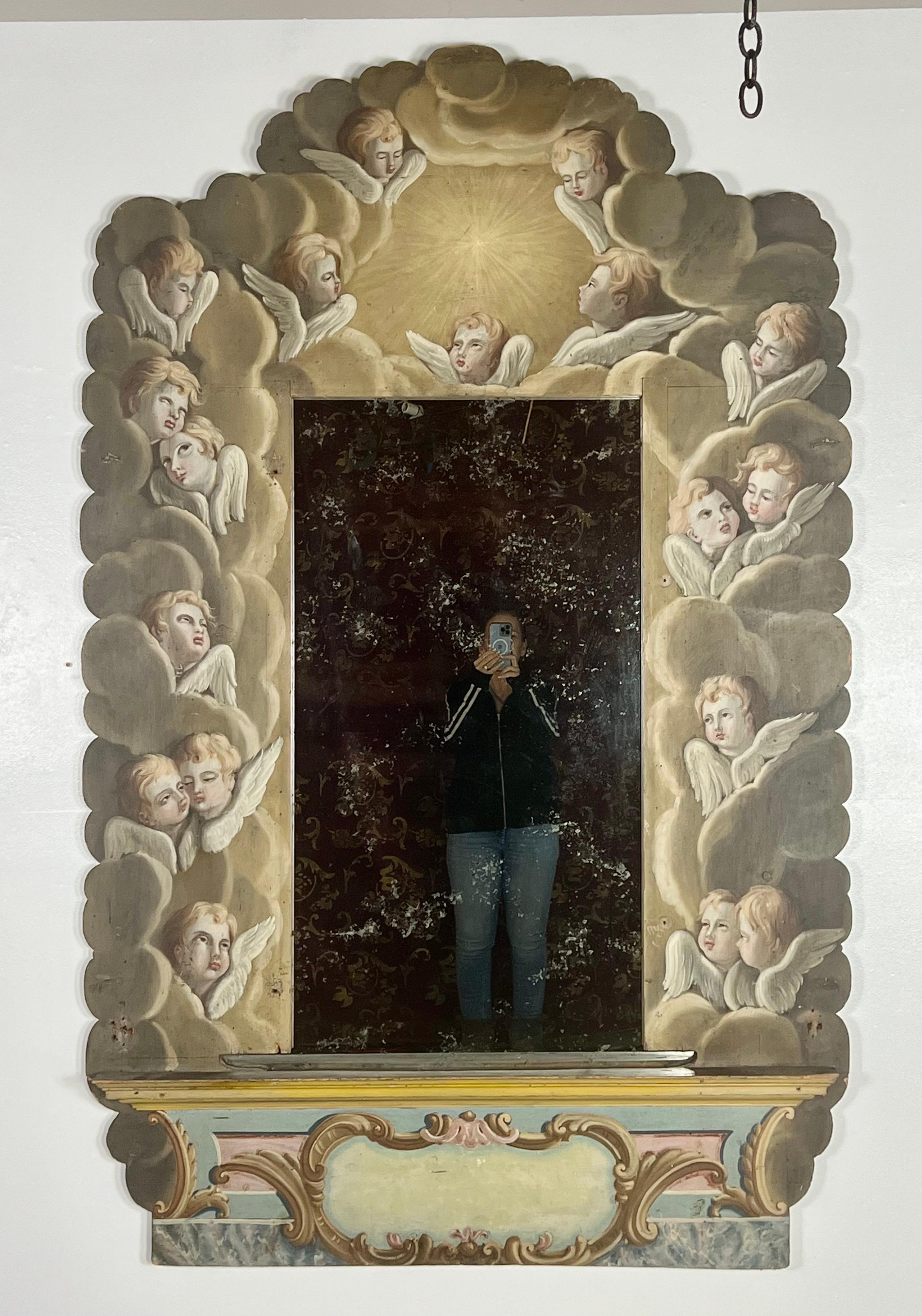 Monumental one-of-a-kind Italian hand painted frame adorned with finely hand-painted winged angel faces though-out. The faces seem to be floating in the heavens having a lovely time. The bottom depicted an empty cartouche surrounded by acanthus