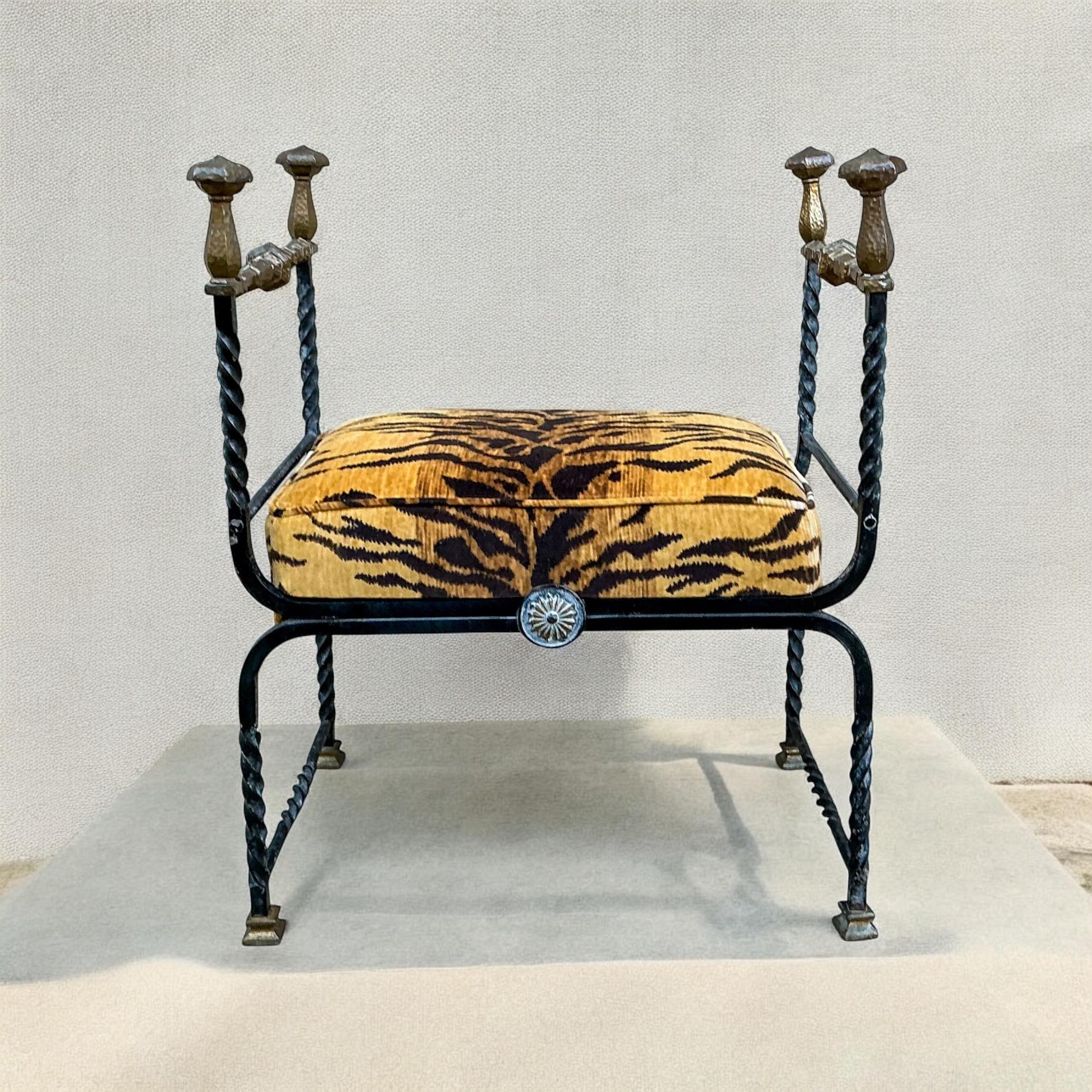 This is a 19th century wrought iron Italian Savonarola bench with bronze accents. The tiger velvet upholstery is new. It is extremely heavy! This piece is very transitional and would work well in both modern and traditional styles.