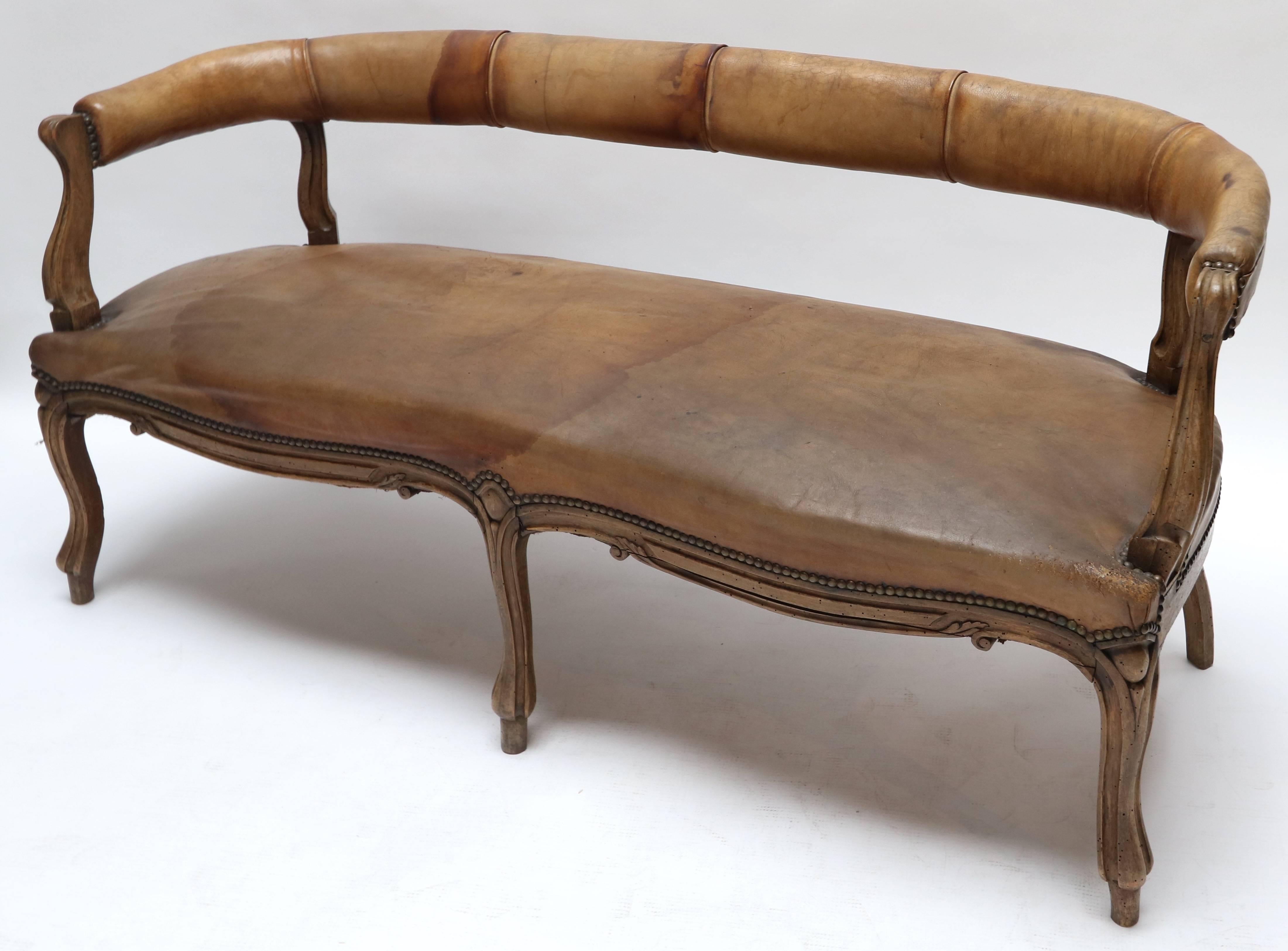 19th century Italian Louis XV style carved wood and leather sofa.