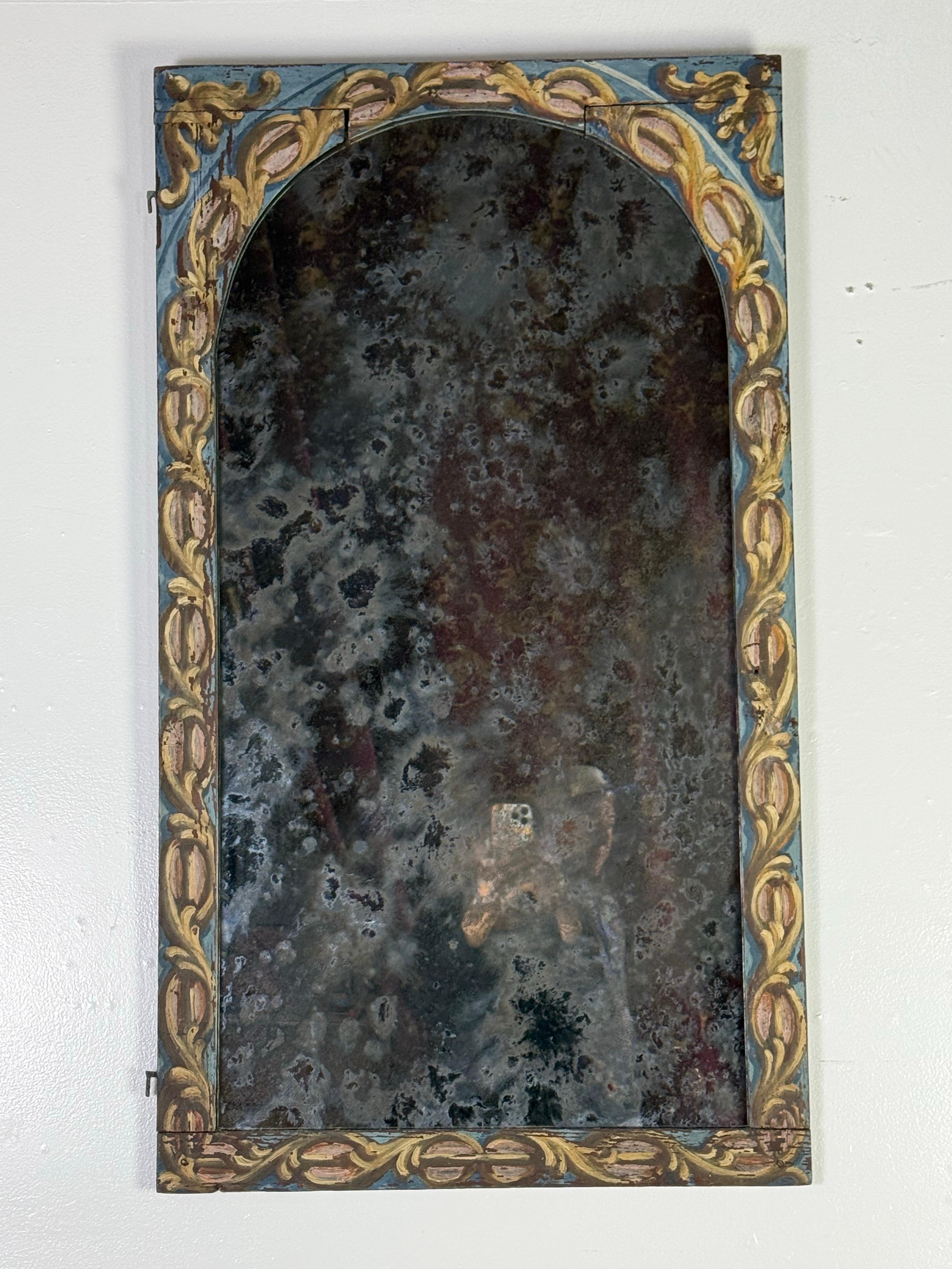 19th C. Italian Baroque style painted arched shaped mirror.  The mirror has a heavily distressed reflective surface, possibly due to oxidation and silvering loss over time.  The mirror has an arched top and is framed in a wooden border with