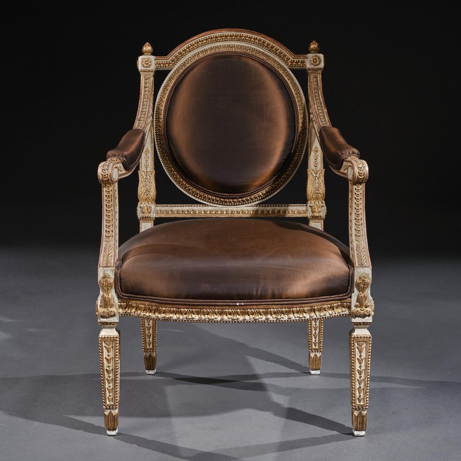 Extremely fine pair of decorative 19th century Italian painted and parcel gilt armchairs of neoclassical design.

Italian late 19th century, circa 1880.

Oozing style these very attractive parcel gilt armchairs have husk and foliate-carved