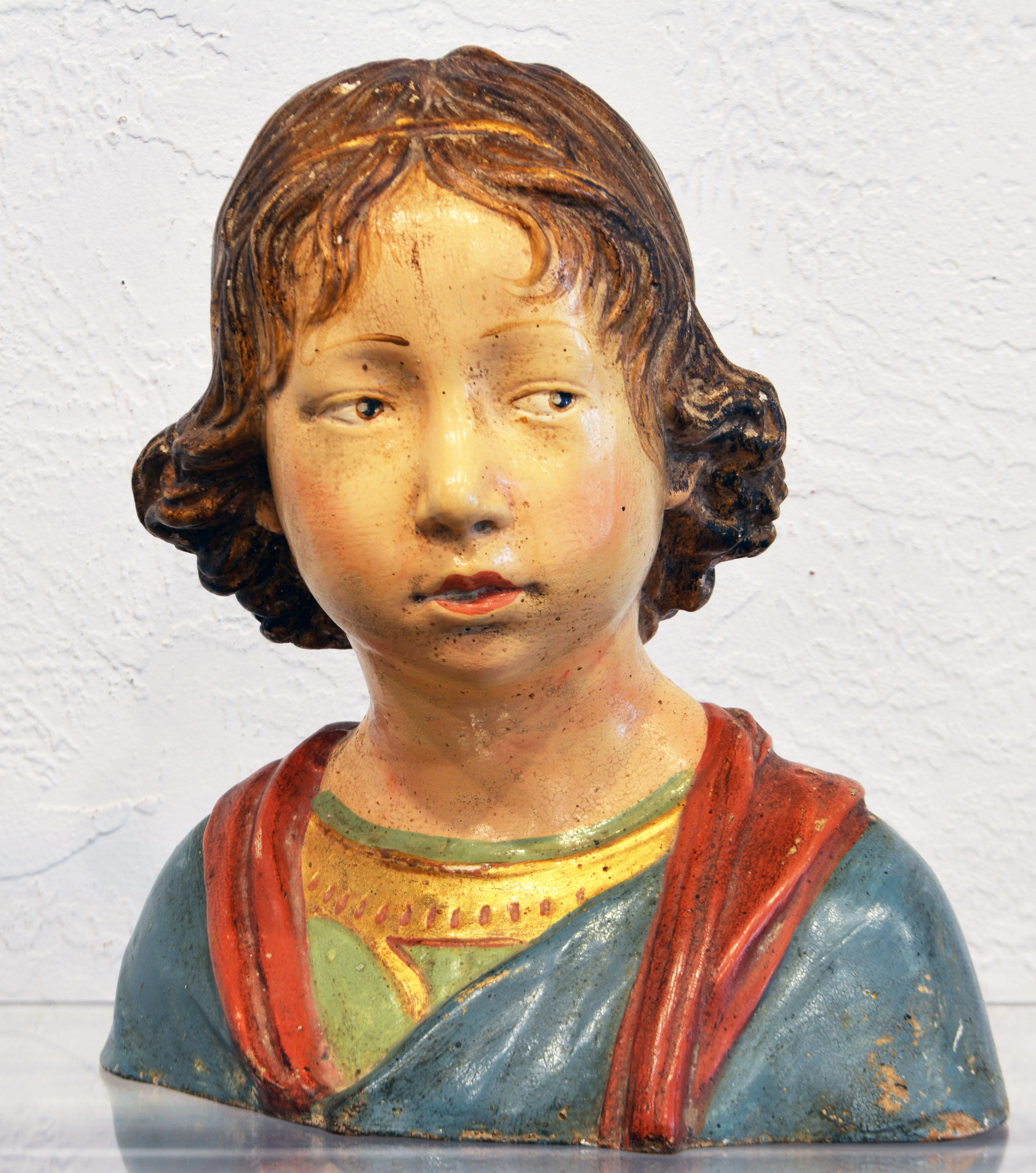 This finely painted and gilt decorated renaissance style terracotta bust is based on a sculpture of a young boy bi Andrea Della Robbia (1439-1525. The boy and his glance is very personalized providing an intriguing feeling of reality. During the