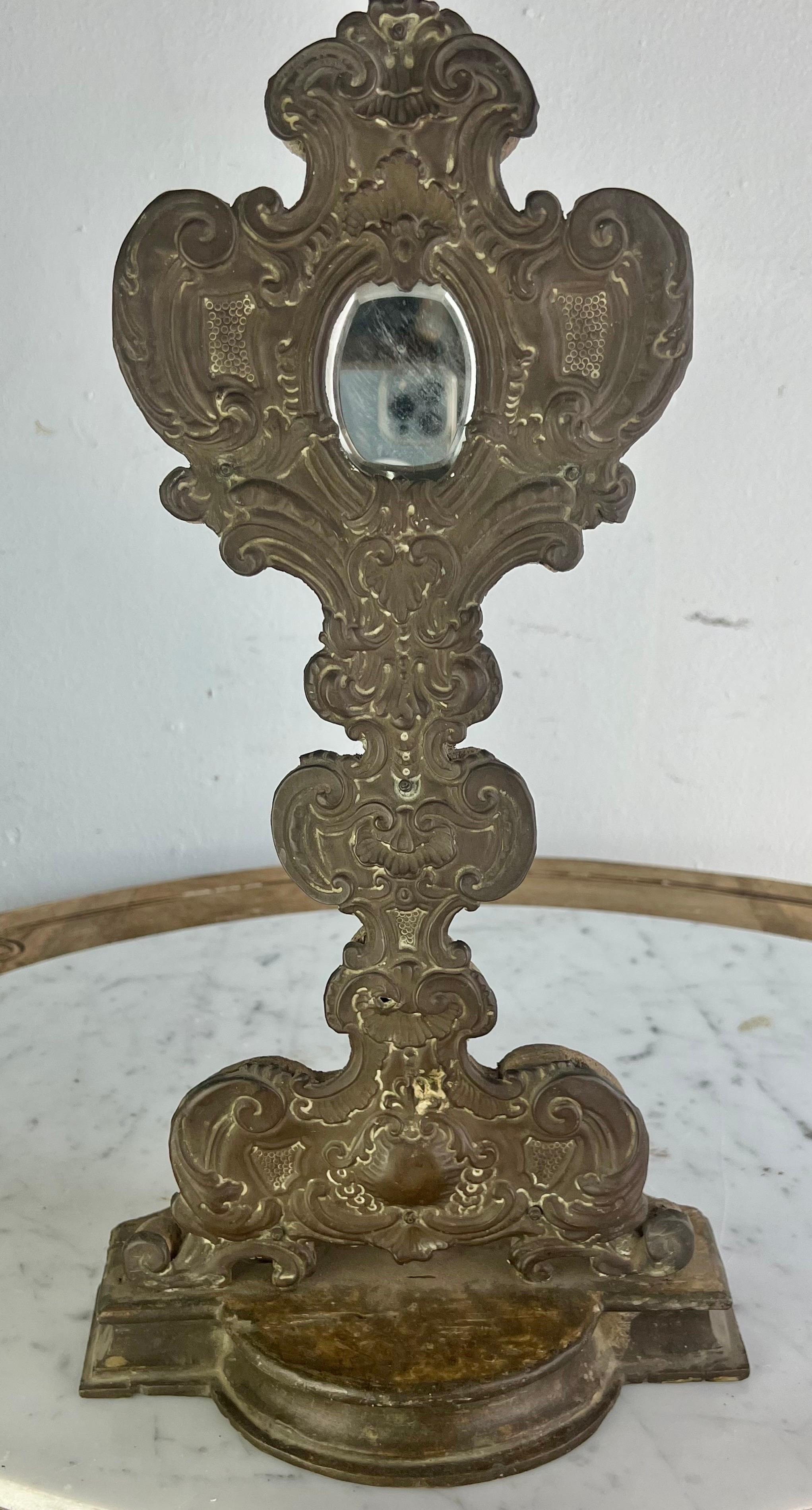 19th Century wood & embossed metal relicquary. The piece originally sat on the alter of the church holding relics. Mirror has been placed where the glass originally held the relics.