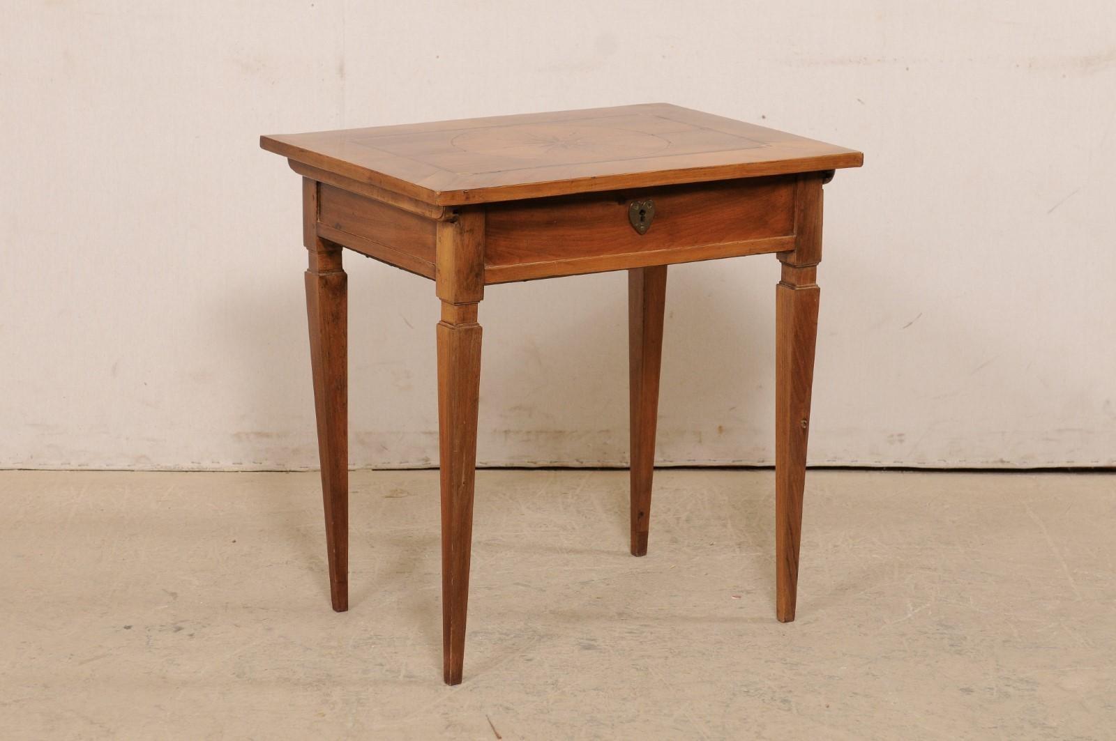 An Italian smaller-sized writing desk with storage hidden beneath top from the 19th century. This super cute desk, or occasional table from Italy, is adorn with beautiful inlay on the top with a circular medallion with flower head at it's center and