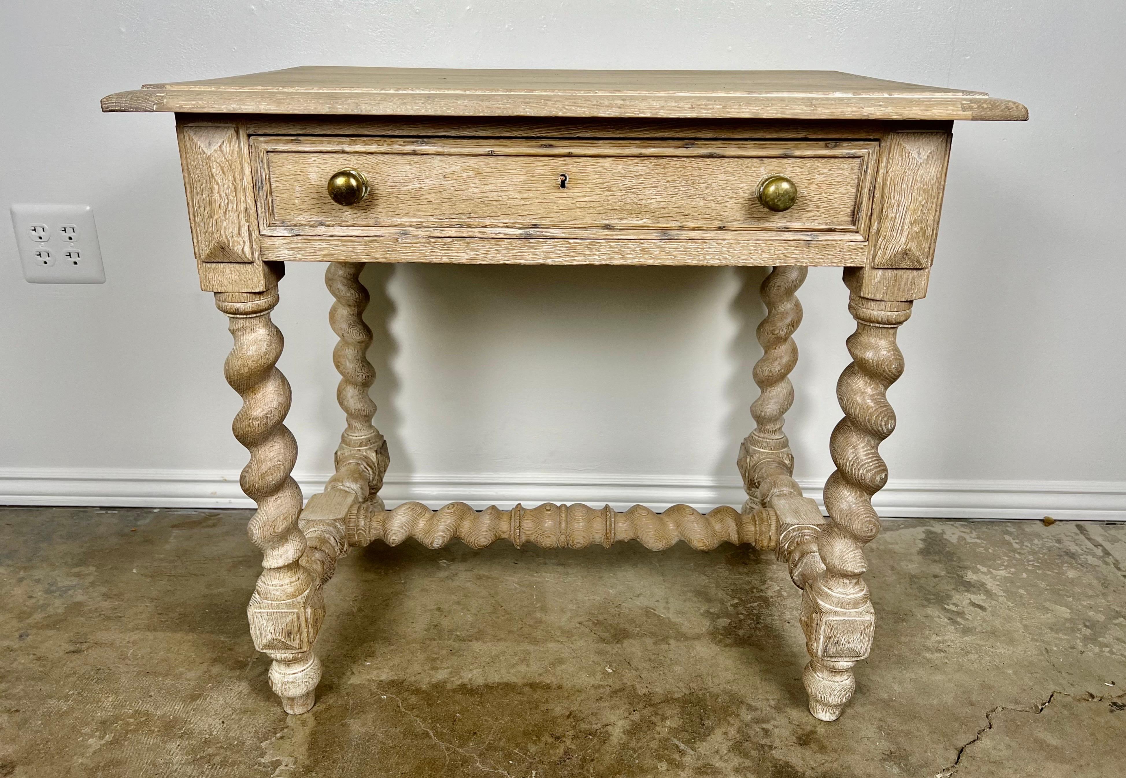 19th Century English Jacobean style table with a single drawer. The rectangular table stand on four barley twist legs connected by a center stretcher. The center drawer is decorated with two original brass knobs.