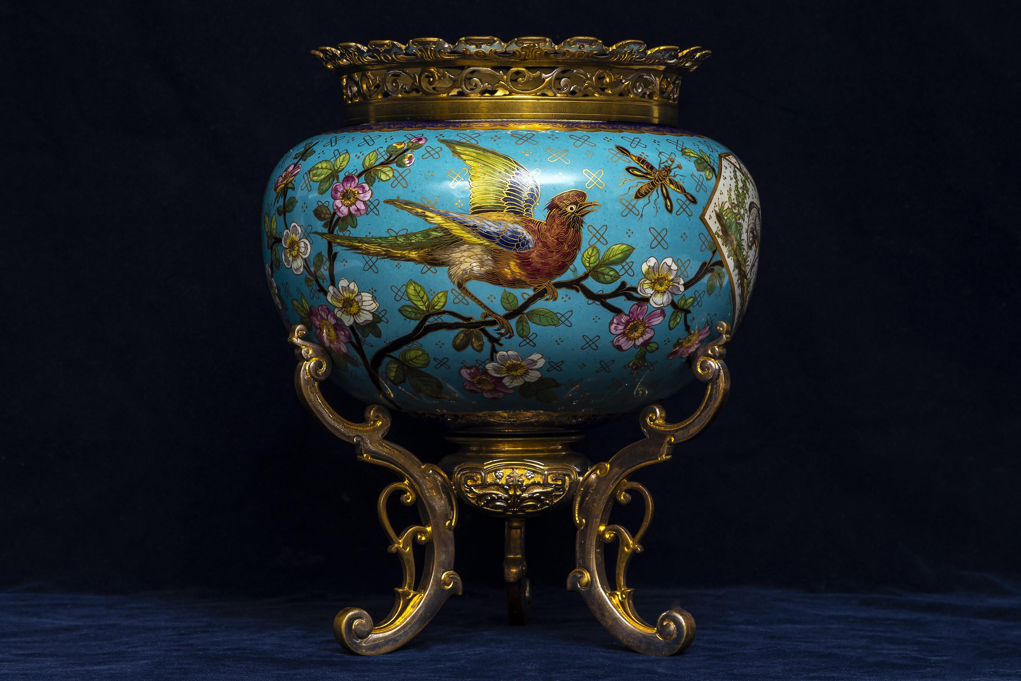 An Antique 19th Century Japanism French Porcelain Jardinière with Gilt and Silvered-Bronze Tri-Footed Stand.  This jardinière is in the Japanism style, resting on an ornate gilt and silvered-bronze tri-footed stand. The jardinière features a rounded