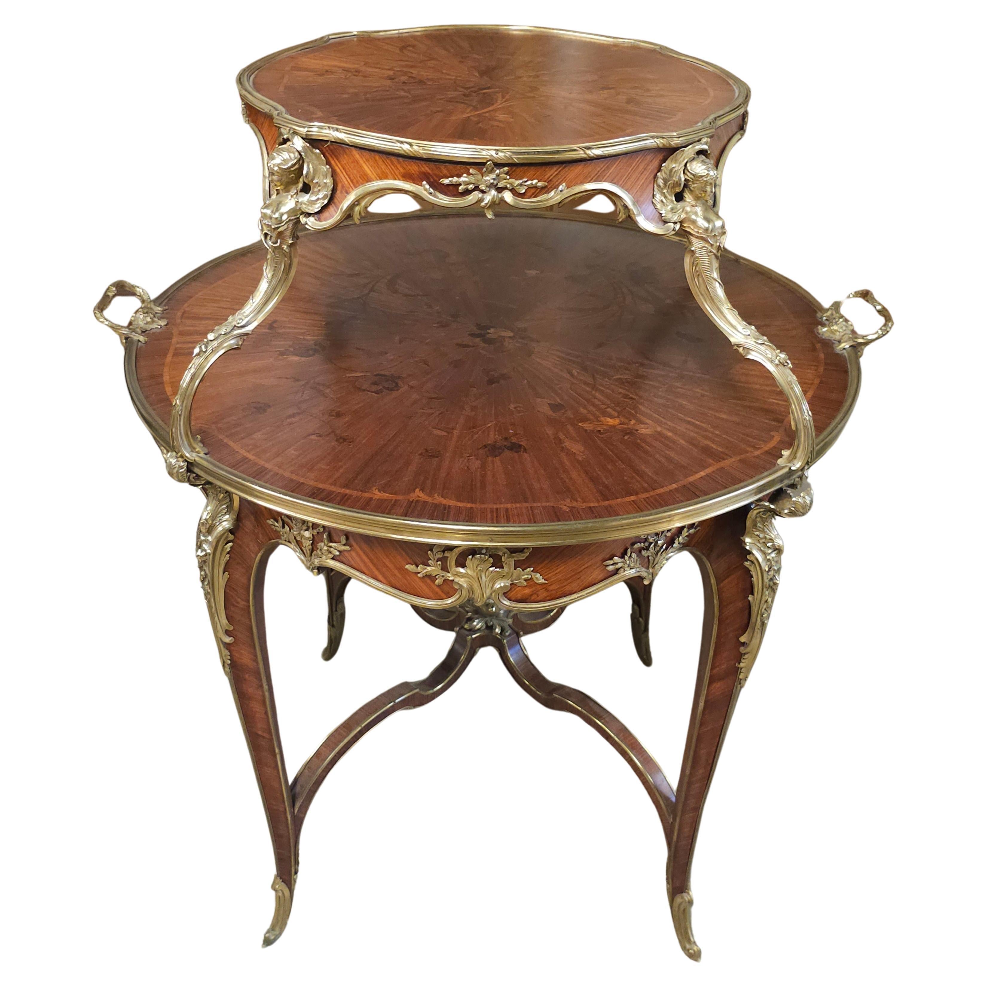 A FRENCH ORMOLU-MOUNTED KINGWOOD, SATINE AND BOIS DE BOUT MARQUETRY TEA-TABLE BY JOSEPH-EMMANUEL ZWIENER (GERMAN-FRENCH, 1848-1925), PARIS, LAST QUARTER 19TH CENTURY. UNDERSIDE OF LOWER TRAY STAMPED E. Zwiemer.

Inlaid with loose floral sprays, the