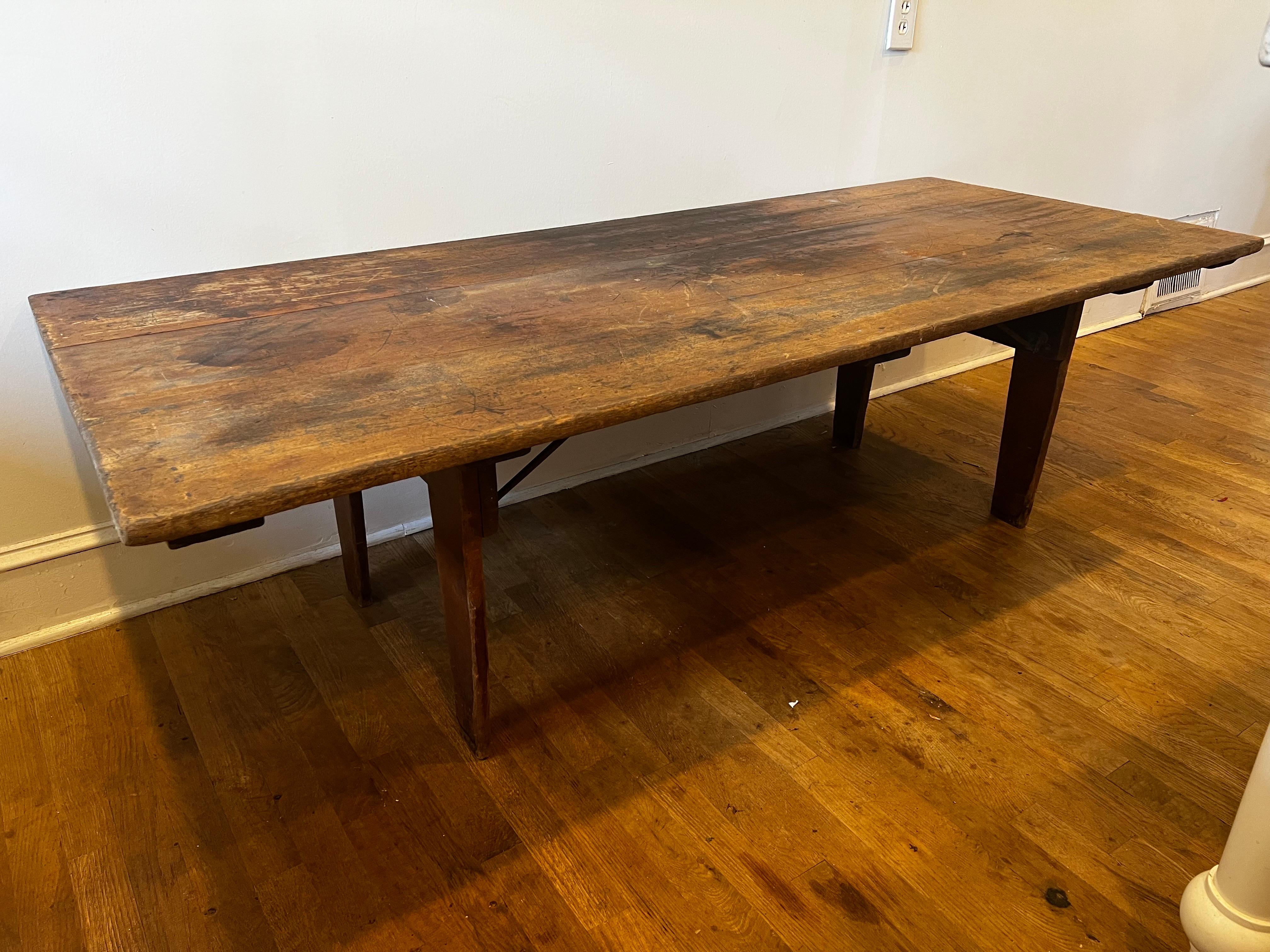 Rare old distressed folding table from the 1800's. 
Original hardware stamped 