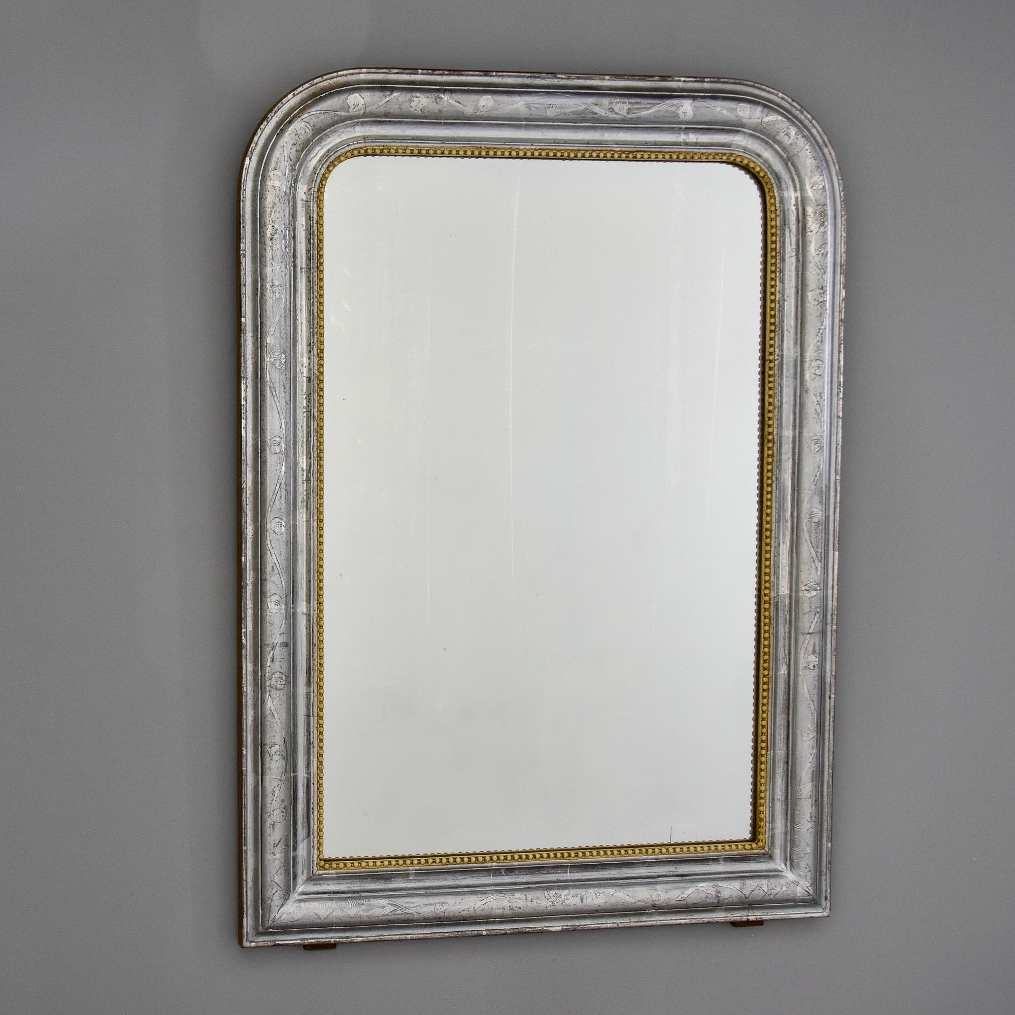 Found in France, this silver leaf Louis Philippe mirror frame dates from the 1870s. Based on the condition of the actual mirror, we think the mirror was replaced at some point. We found the mirror in France as shown. Frame has etched leaf and vine