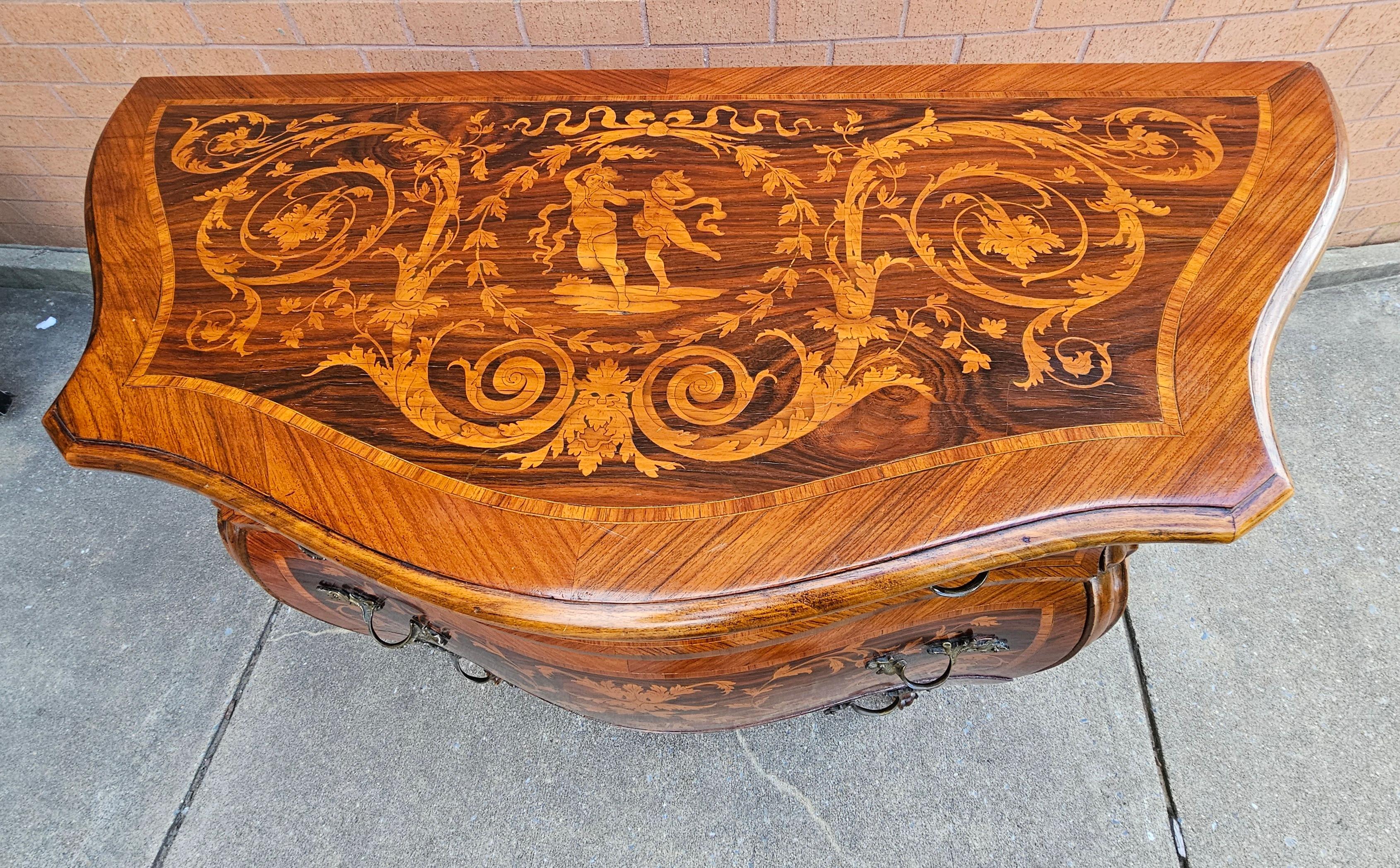 An Absolutely gorgeous late 19th Century Lombard Italian Rococo style Marquetry Kingwood,  Tulipwood and Satinwood Bombé Commode in great antique condition.  Three drawers with French style pulls. Measures 43.25