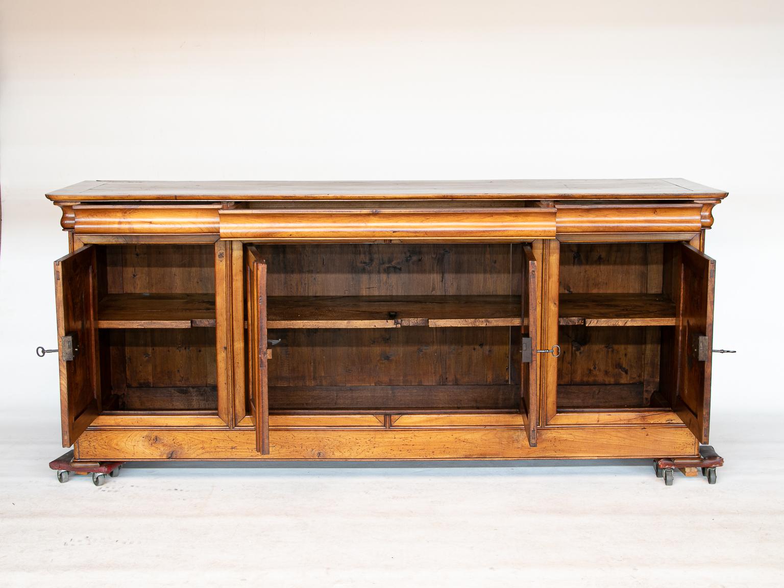 19th C. Louis Philippe cherrywood enfilade 
19th C. Louis Philippe cherrywood enfilade with four doors opening revealing ample storage. There are three drawers with an ogee curve and notice the large center drawer. The finish looks even better in