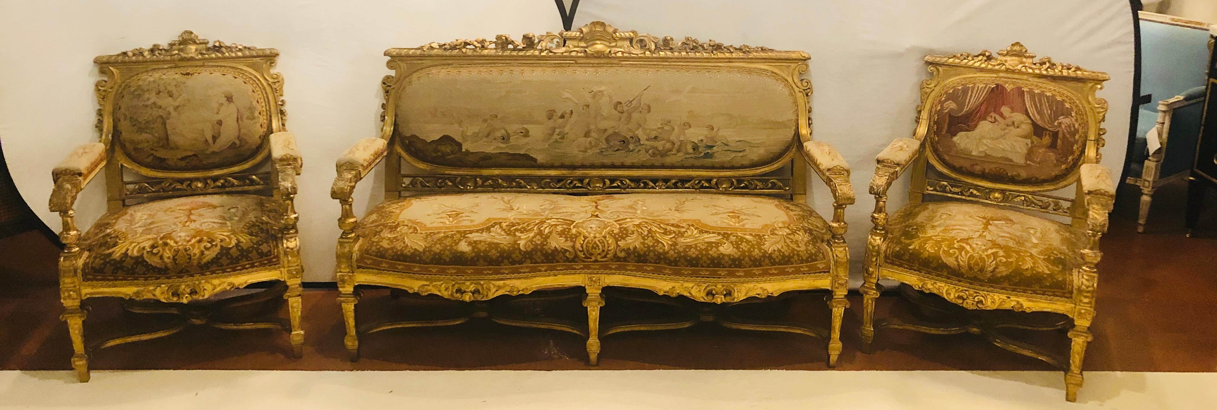 19th century Louis XIV Style Parlor Suite / Salon set three-piece French giltwood petite point and gros point in spectacular shape given the age. The giltwood frame strong an sturdy and the upholstery bright and colorful. A lovely settee canapé and