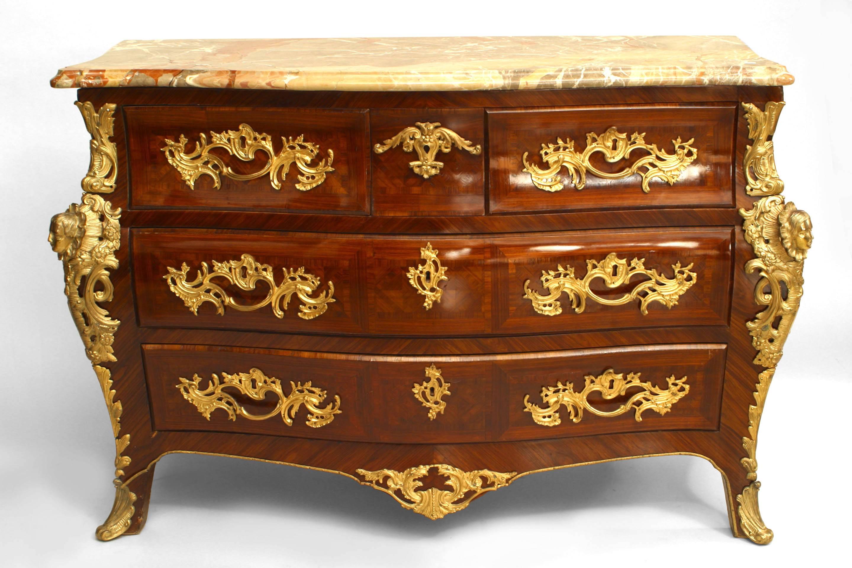 French Louis XV style (19th Century with some mount replacements) kingwood commode with 3 drawers and bronze trim with a marble top.
