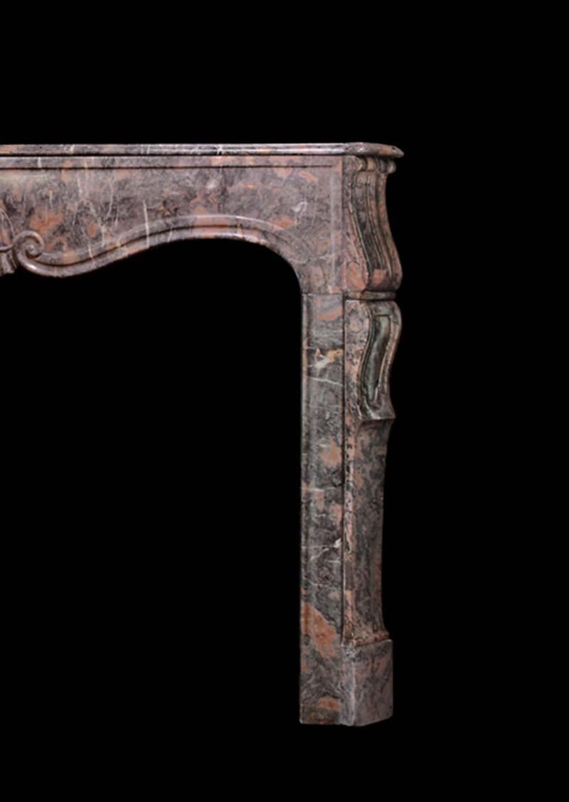 A 19th c. Rouge Royale marble Louis XV style mantel with simple motif carved frieze. 
Opening Dimensions: 42.5