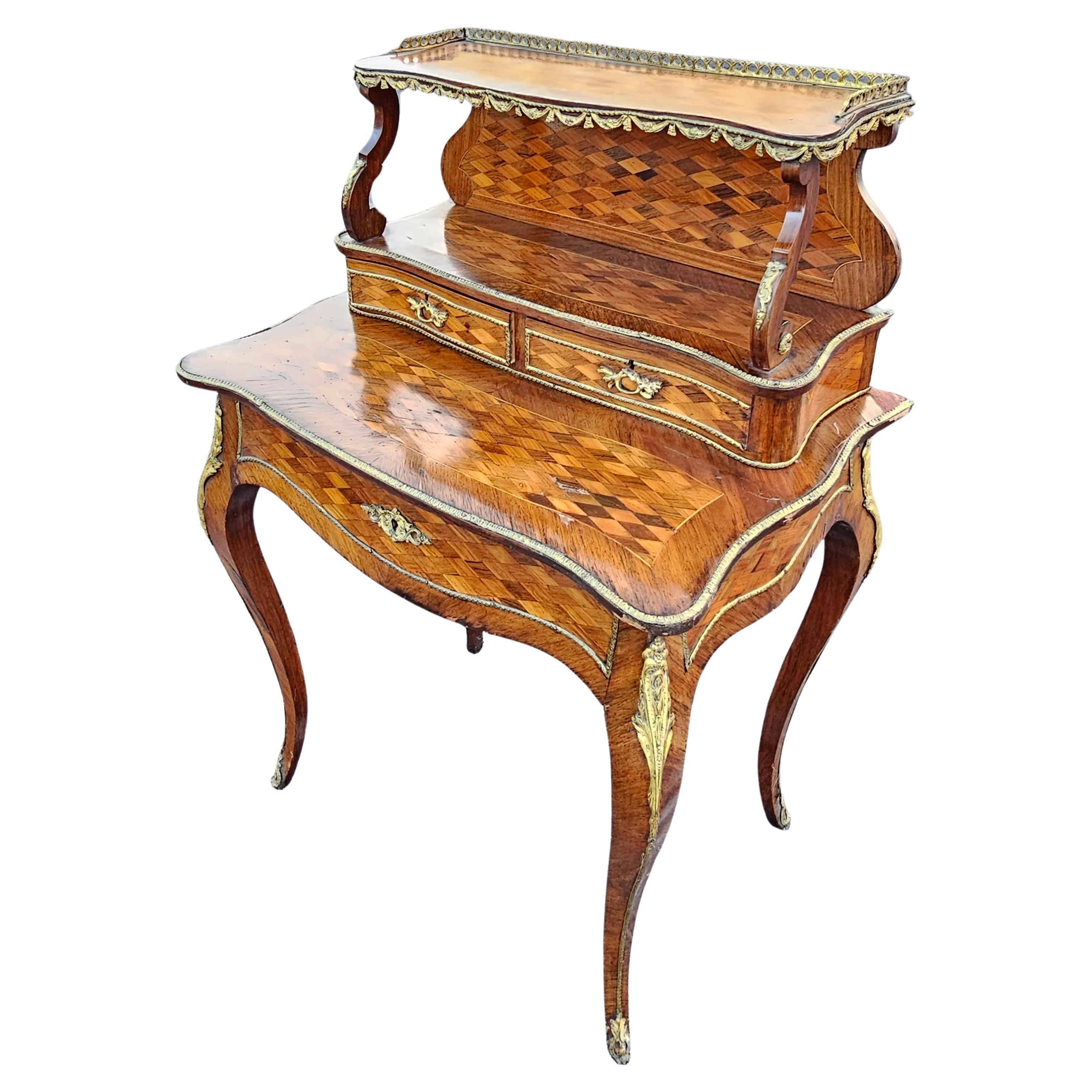 A 19th Century French Louis XV Style kingwood and Walnut marquetry, ormolu mounted and galleried bonheur du jour, the top marquetry and galleried details. Two upper smaller drawers measuring 10