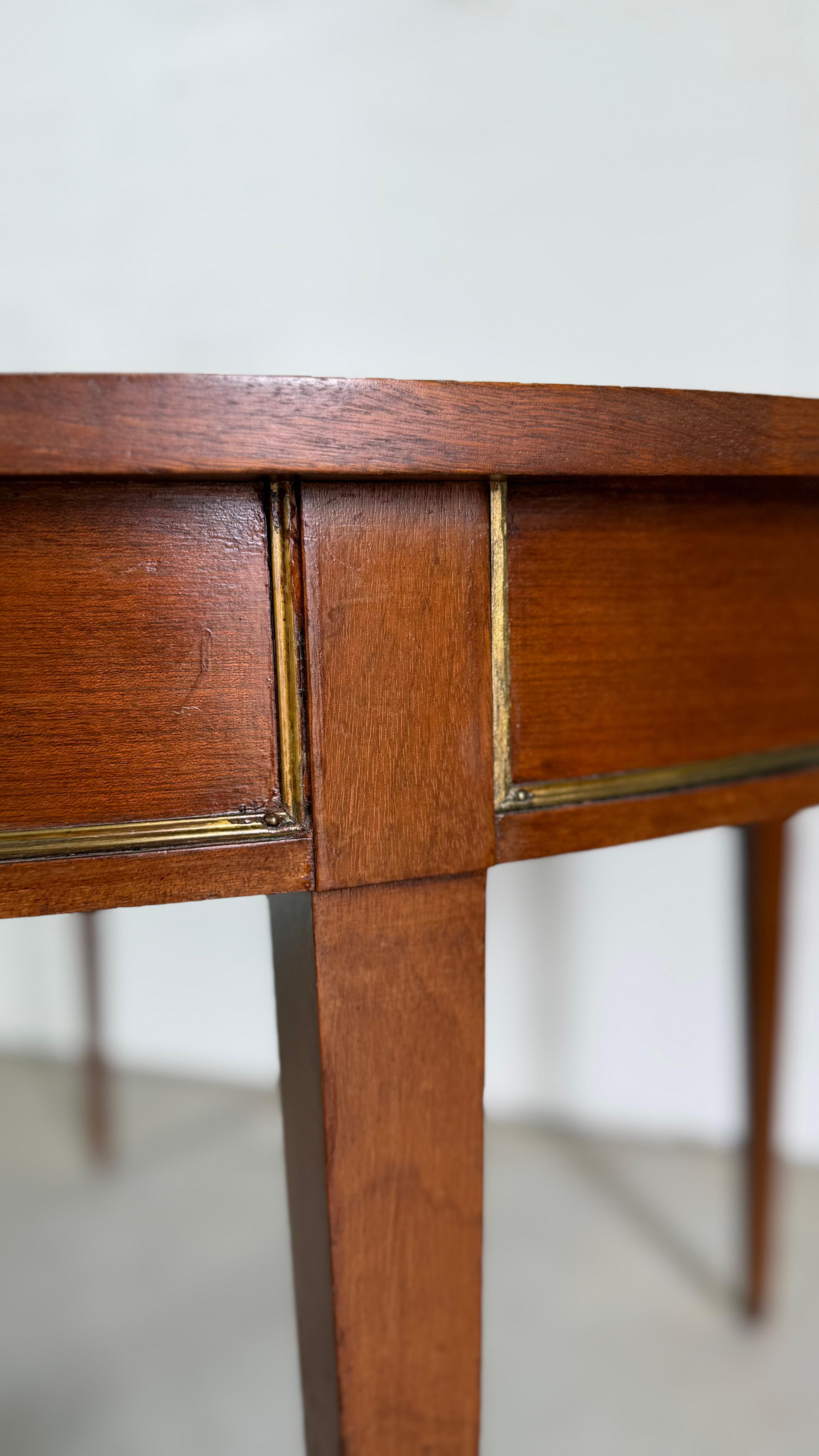 Refined and stately, this 19th-century Louis XVI dining table embodies the timeless elegance of French neoclassical design. Crafted with precision and grace, the table features fluted legs, clean lines, and delicate carved details characteristic of