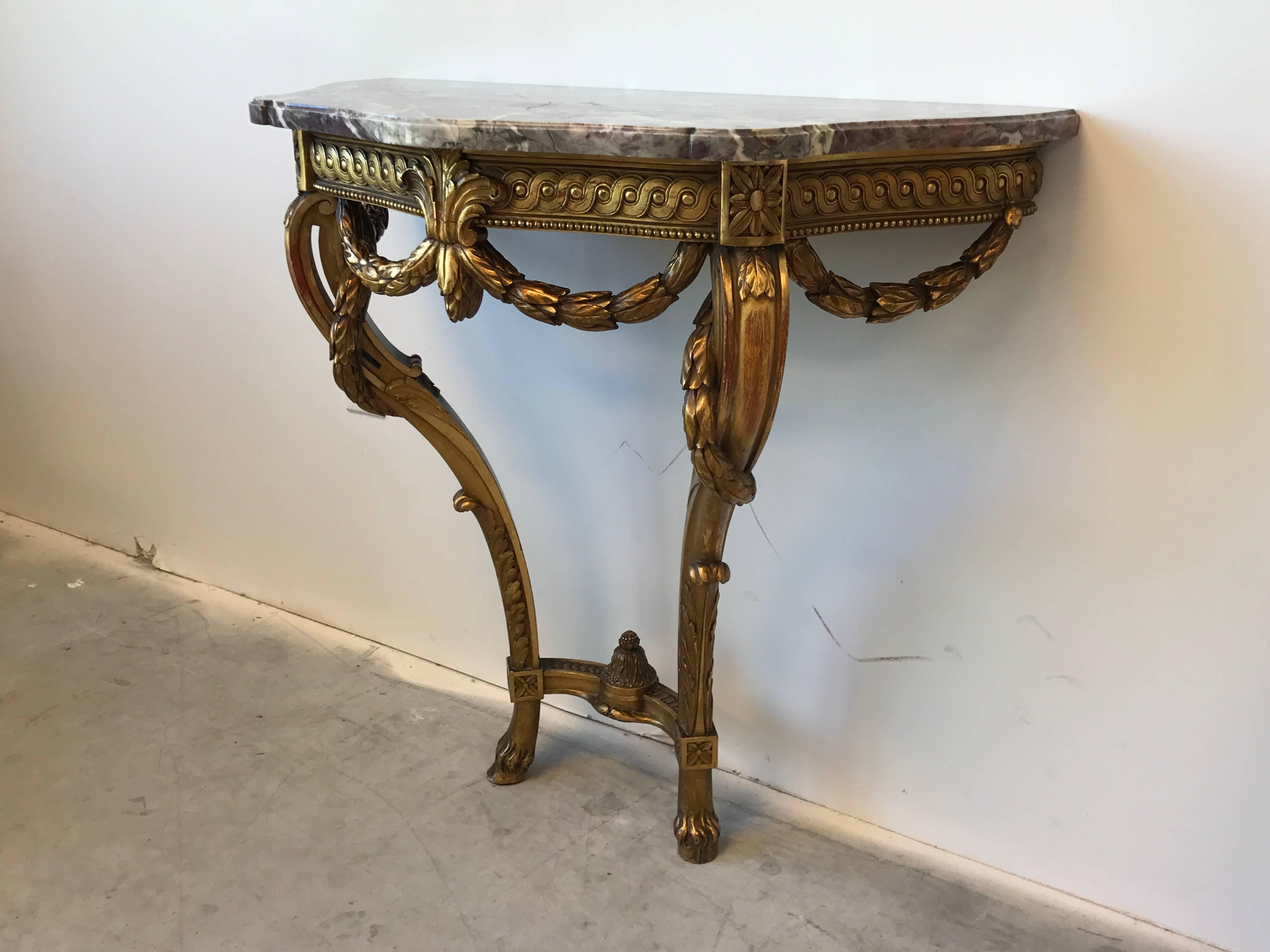 Offered is a stunning, 19th century, Louis XVI style French giltwood demilune wall-mount console table with marble top. Marble top is removable for easier transport. Heavy.