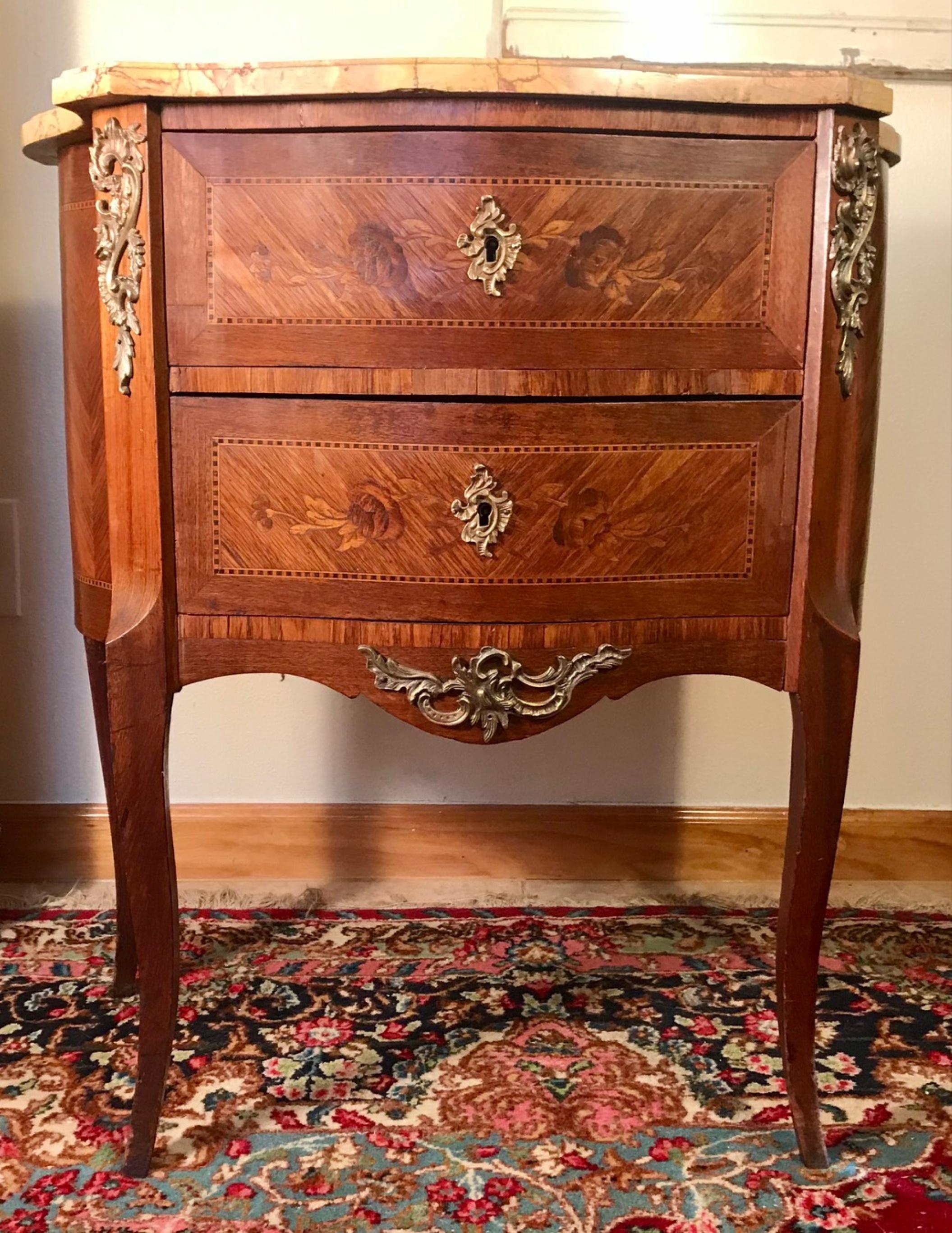 19th Century Louis XVI Style Marquetry 2-drawer Siena Marble Commode 

This Louis XVI style commode is beautifully veneered and decorated with intricate marquetry work on 3 sides. The 2-drawer body is set on slender and graceful cabriole legs.