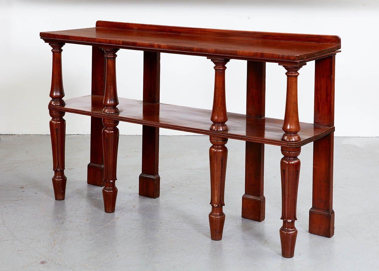 An etagere with long, narrow proportions, crafted of high quality mahogany with a glowing patina, with two shelves of solid, single planks of hand-hewn mahogany, the top shelf with raised back lip and the second shelf with reeded edge, both shelves