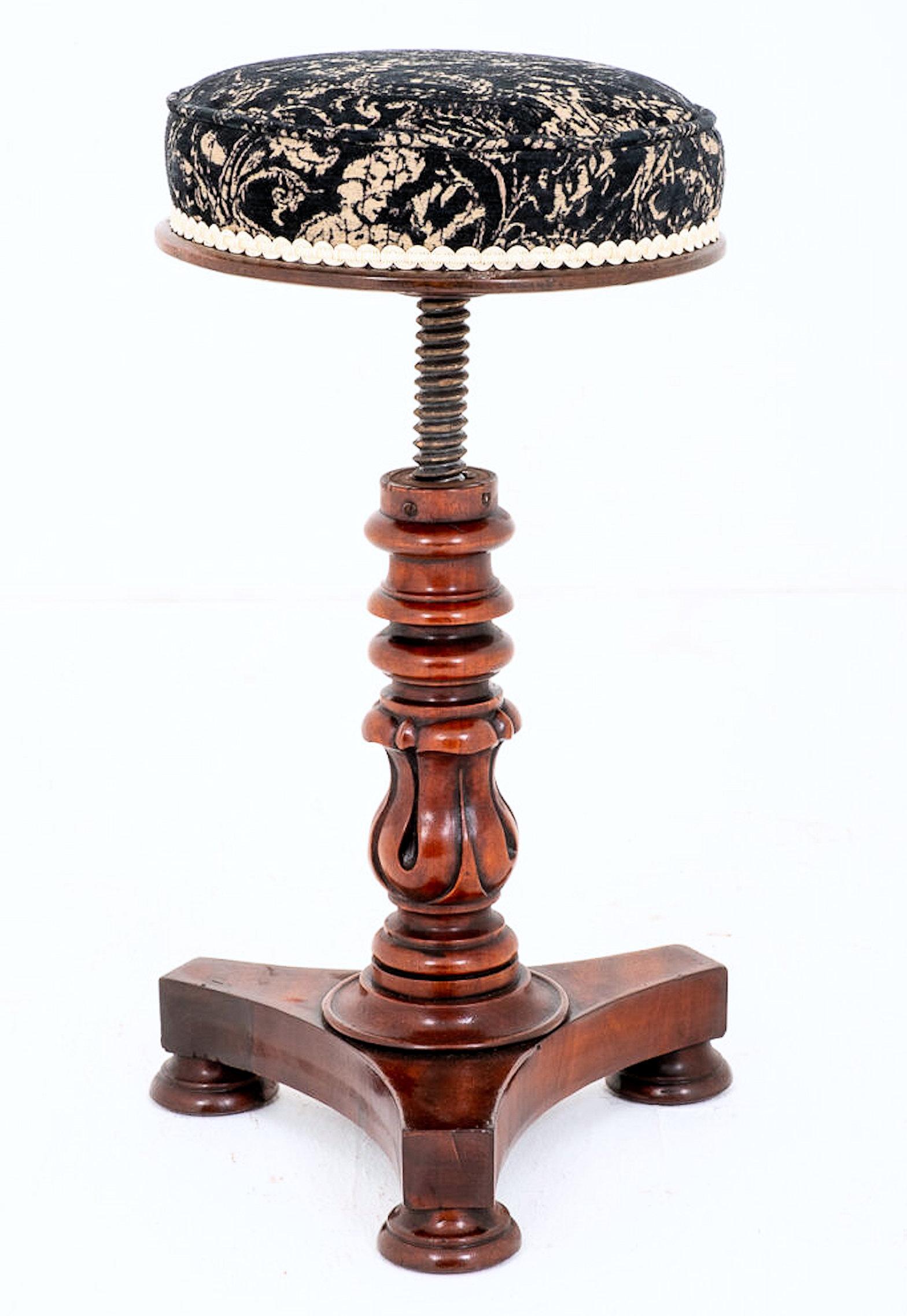 This very handsome and beautifully carved mahogany piano stool features an adjustable seat supported on a tulip shaped central column on a triangular shaped base ending with 3 bun feet. The stool measures 21 in – 53.4 cm extending to a maximum