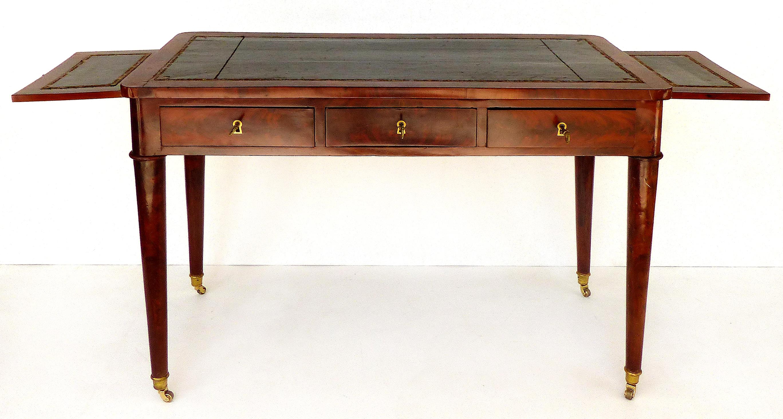 19th-Century Mahogany Writing Desk with Tapering Legs and Embossed Leather Top

Offered for sale is a fine 19th-century flame mahogany three drawer writing desk with a black embossed leather top and surface extensions. The four conical tapering legs